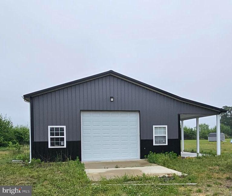 A rare rural opportunity—2.4 acres featuring a 30' x 40' pole building equipped with well and electric. The building includes two garage doors with automatic openers, a convenient side entry door, and an impressive 10' x 20' lean‑to/porch, offering exceptional flexibility for storage, workshop use, or future expansion.
Inside, the building is already outfitted with a full bathroom, complete with shower, commode, and sink. A dedicated utility room houses the water heater and water tank, adding even more functionality. A septic system will be needed, giving the next owner the freedom to design the property to suit their vision. 
A 4" well with submersible pump is present on the property. 
This could be your ultimate "barndominium"!