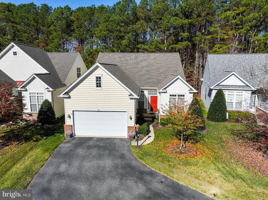 MOTIVATED SELLER ALL REASONABLE OFFERS WILL BE CONSIDERED ! MAJOR PRICE ADJUSTMENT! Discover this stunning Royal Tern model home featuring four spacious bedrooms and three bathrooms. Located in a vibrant 55+ community The Parke at Ocean Pines just minutes away from the beautiful beaches of Ocean City. Enjoy the grandeur of cathedral ceilings and a skylight that brightens the living space.   Inside, you'll find elegant hardwood floors, crown molding, formal dining room and chef style kitchen. Relax in your secluded primary suite with  tray ceilings with primary bath and huge walk in closet.  The inviting see-through fireplace off great room and sunroom adds warmth to the atmosphere. Step outside to a beautifully landscaped large backyard, perfect for entertaining, complete with a brick patio. The expansive driveway leads to a garage with a convenient 4-foot extension. Recent upgrades include a new roof, an HVAC system , a vented foundation with a sump pump, and a vapor barrier. This home also comes with a termite warranty and new smoke detectors. Call now for your private showing