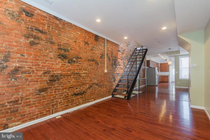 Beautifully renovated home on a tree-lined street of Butchers Hill. The house offers spacious and airy first level with an open floor plan, gleaming hardwood floors, exposed brick and high ceilings, renovated kitchen with granite and stainless steel appliances, and a main level half bath.  Second floors offers 2 bedroom suites - both with ensuite full baths, and convenient bedroom laundry.  The finished lower level could be used as a guest bedroom, office or a den. Close to Johns Hopkins, Fells Point, Harbor East and Canton. Available for occupancy immediately.