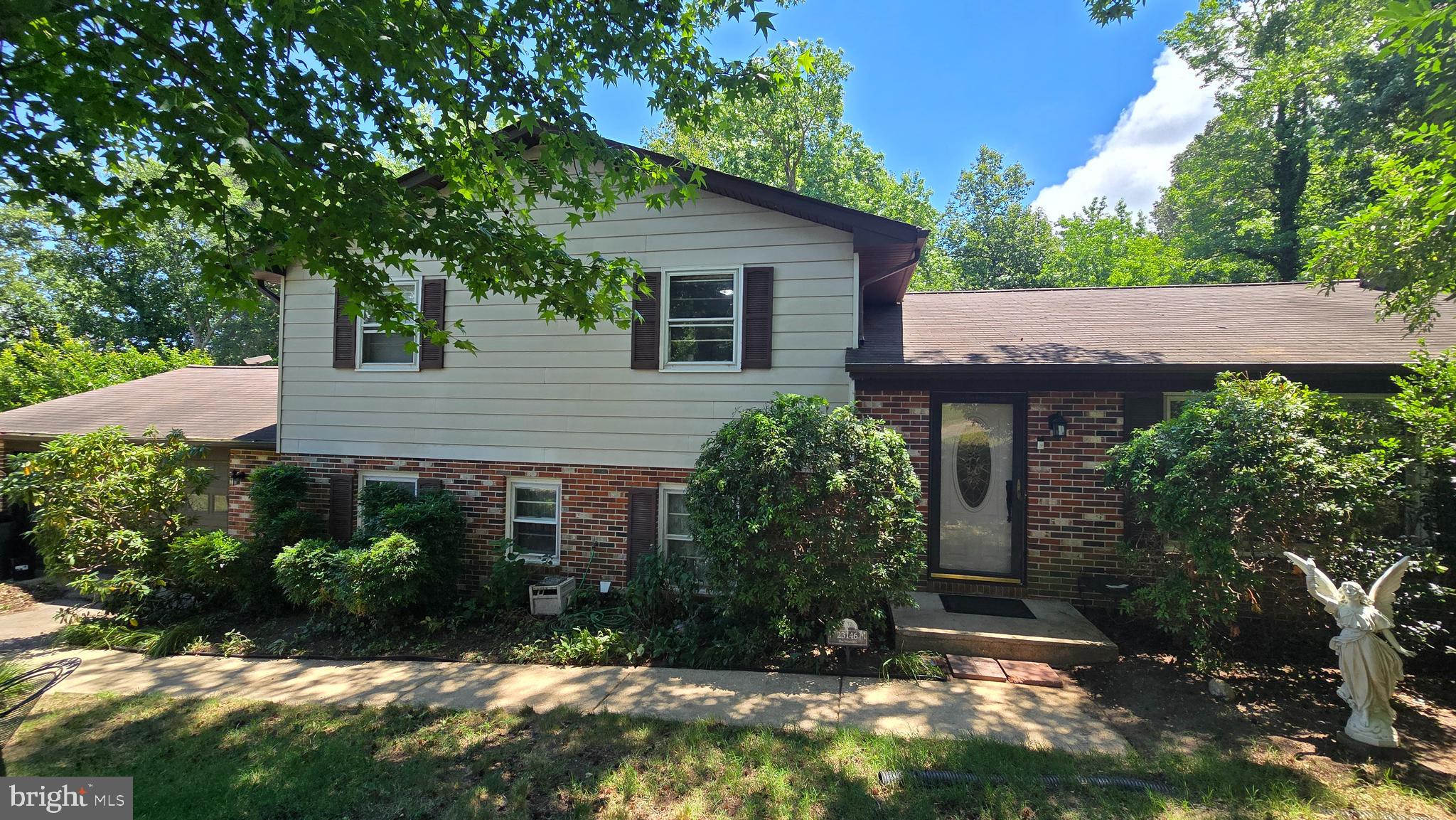 Welcome to the highly sought-after community of Esperanza Farms! This sturdy 4-level split-level home, constructed with a durable brick and vinyl siding exterior, offers a spacious 2,800-square-foot traditional layout on a generous 0.55-acre lot.  Perfect for those looking to build sweat equity, this property provides an incredible opportunity to customize a home in a premium neighborhood to your exact vision. 

The heart of the home is a traditional kitchen featuring upgraded countertops, a movable island, a double sink, and high-end appliances including a Bosch dishwasher, double wall ovens, a cooktop, and a double-door refrigerator with an ice and water dispenser. Adjacent to the kitchen and dining area is a sprawling family room, creating a seamless flow for daily life. Throughout the main levels, you will find classic architectural details such as hardwood floors, chair railing in the dining and family rooms, and crown molding in select spaces. Many rooms are also equipped with ceiling fans for added comfort. 

The bedroom levels feature both stall showers and tub-shower combinations. The fourth, lowest level is a fully finished basement that offers great versatility with a dedicated exit door, a closet, and a window—ideal for an unofficial fifth bedroom, private studio, or playroom. Practicality meets convenience with three separate attic spaces (two in the house and one in the garage) for abundant storage. The two-car attached garage is a hobbyist's dream, featuring built-in storage and a sturdy workbench. 

The exterior features a circular paved driveway and a backyard patio for outdoor gatherings. The large lot is filled with mature trees and established bushes, offering a serene atmosphere. Residents of Esperanza Farms enjoy exclusive access to private community water access featuring protective rip-rap, perfect for quiet moments near the water. 

Key infrastructure updates provide peace of mind, including a roof installed in 2012 and a hot water heater replaced in 2018. The home is serviced by central air conditioning and oil heat. Please note that the fireplace is currently inoperable and the property contains an underground oil tank. This home is being sold strictly As-Is with a property disclaimer. Located just minutes from NAS Patuxent River, shopping, and dining, 23146 Esperanza Drive is ready for its next chapter.