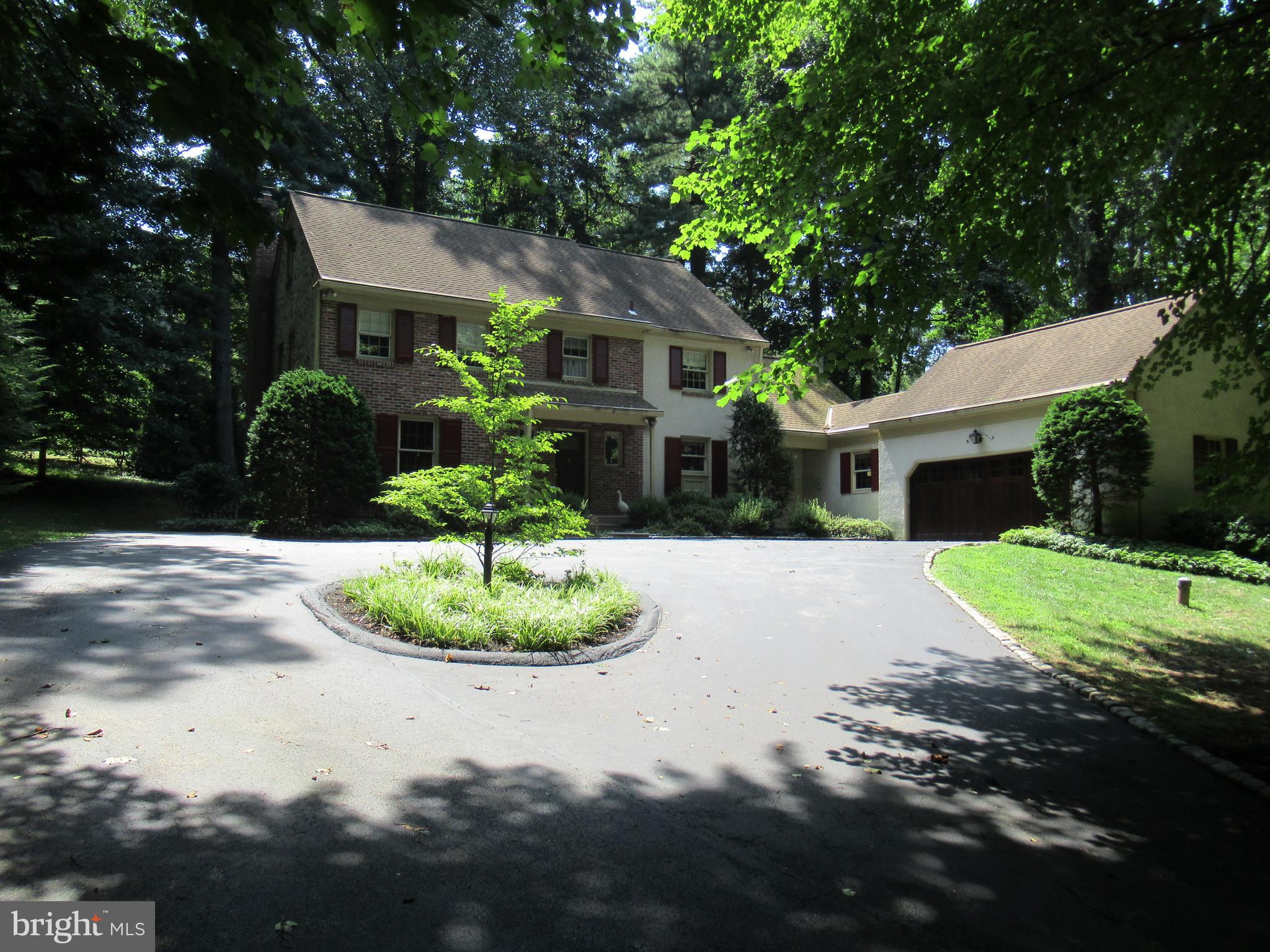 A welcoming circular drive introduces you to a traditional two-story brick colonial situated on a 0.92-acre wooded lot. The driveway runs up the left side of the property to a large two car garage and ample parking. A walkway from the circular drive leads to the front entrance and charming center hall. The first floor living area consists of an eat-in kitchen which opens into the cozy den with gas fireplace; a formal dining room which seats 12 comfortably; living room with a wood burning fireplace; bright library/office room; powder room; and laundry area with entrance to garage. The upper level has 5 hardwood floored bedrooms and two full baths. The floored attic is accessed from fixed stairs. The full basement is partially finished with high ceilings. The home is located within walking distance to the center of Bryn Mawr, Bryn Mawr Hospital, restaurants and Amtrak connecting to Philadelphia 30th street station. The home is in the award-winning Radnor Township School District.