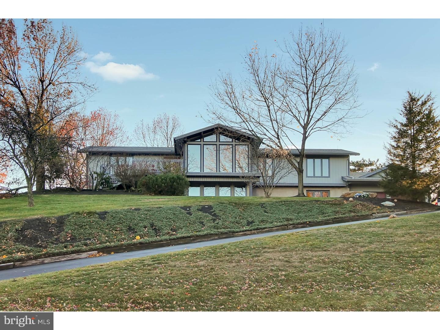 If you are looking for a home with the WOW FACTOR, this is it!  This stunning home has it all, including one floor living on the main level.  The gourmet kitchen will delight any cook with a large butcher block island, sub zero frig, and a 10 foot long butler's pantry for plenty of storage.  There is also a beautiful sunroom off the kitchen, as well as a formal dining room, for plenty of extra space.  The grand living room speaks for itself with vaulted ceilings, exposed beams, a floor to ceiling brick wood-burning fireplace, and a sitting area that surrounds you with windows that look out to an amazing view.  The elegant staircase leads down to the finished basement where you will find a family room with its own pellet stove, a game room with recessed lighting and a bar for entertaining, and a third full bathroom/laundry room.  This space even has its own exit so it could easily be used as a in-law suite.  And did I mention that this home has a 3-car garage?  You can park in two of them and have an awesome workshop in the third.  And outside there is a great backyard complete with privacy fence.  This spectacular home also has new kitchen flooring, new carpets, new roof (2015), new heater with 5 zone heating (2006), a security system, and it comes with a one-year HMS home warranty!  So schedule your private showing today before this home is gone!