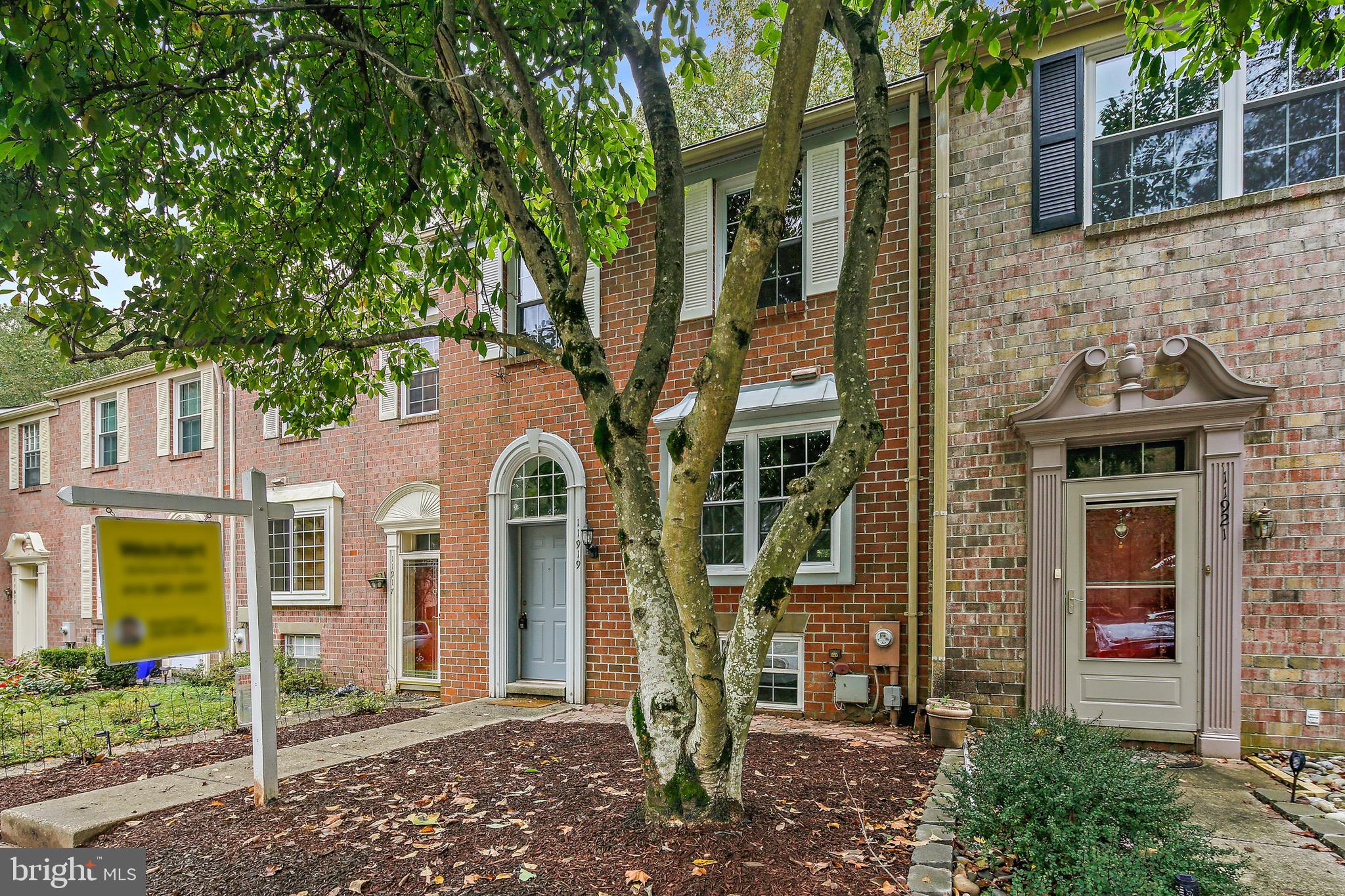 Brick front townhome with three finished levels!  The eat-in kitchen features granite countertops and stainless steel appliances. Enjoy the main level hardwood floors and a large and bright living room that offers ample room to relax. French doors take you from the living room to a deck nestled among trees! The upper level offers three bedrooms and two baths including the owner's suite with a lovely large walk-in closet and full bath. The lower level is finished with a brick fireplace, fourth bedroom or home office plus an additional full bath and walks out to a private patio.