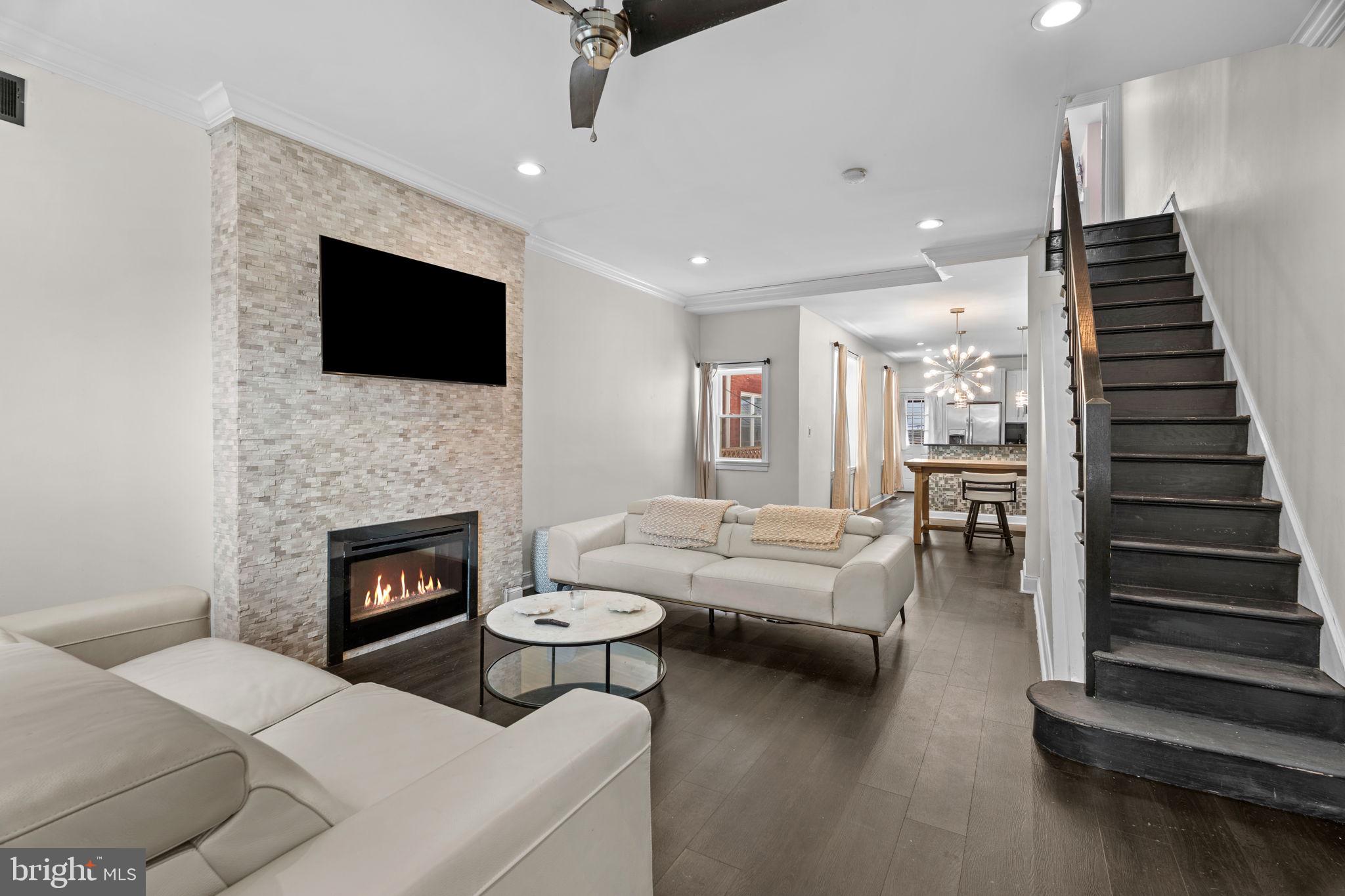 Welcome to 842 N. 28th Street—an absolute showstopper in the heart of Fairmount. Beautifully renovated, impeccably maintained, and packed with character, this 2-bedroom, 1.5-bath home with finished basement offers something incredibly rare: a backyard oasis that feels like a private resort in the middle of the city! Enter a sun-drenched living space featuring a stunning stone fireplace wall, an oversized front window, a separate dining area, and a gorgeous custom kitchen with black granite countertops and breakfast bar seating. The finished basement adds valuable living space and is perfect for a family room, media room, home office, or gym, offering plenty of storage and natural light. Upstairs, original details shine throughout. The rear bedroom features a bay window, fireplace mantel, and stained-glass door, while the spacious primary bedroom offers beautiful built-ins and an expanded walk-in closet. The oversized bathroom feels like a spa, featuring a glass-enclosed shower and a separate jacuzzi tub. Located on one of Fairmount's most desirable blocks, just steps from parks, restaurants, Kelly Drive, Whole Foods, and the Parkway. Homes like this don't come around often. Unique, stylish, and completely move-in ready—842 N. 28th Street is the one you've been waiting for.