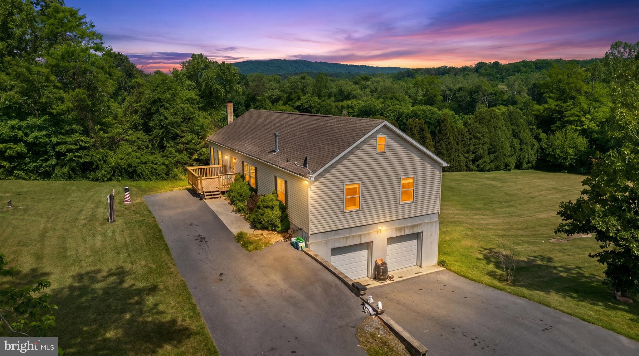 scape to the beauty of Morgan County with this spacious ranch-style home nestled on 1.26 unrestricted acres in Great Cacapon. Offering approximately 2,854 square feet of living space, this well-maintained home features generously sized rooms, an open and inviting layout, and abundant storage throughout. The large eat-in kitchen boasts ample cabinetry, recessed lighting, and plenty of space for gathering with family and friends. Spacious bedrooms include walk-in closets, while crown molding adds a touch of elegance throughout the home. A finished walkout lower level provides endless possibilities for a recreation room, home office, gym, or additional living space. The oversized two-car garage includes a workshop area, and the unfinished attic offers tremendous potential for future expansion or storage. Enjoy the peaceful setting with mature trees, apple trees, mountain views, and room to roam, all just minutes from downtown Berkeley Springs, dining, shopping, and outdoor recreation. A rare opportunity to enjoy country living with convenience nearby.