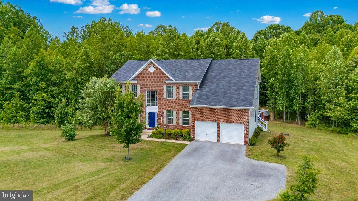 Welcome to this exceptional Colonial home, built in 2021 and offering more than 6,400 square feet of finished living space. Situated at the end of a quiet cul-de-sac on a generous 6.32-acre lot, this remarkable property offers exceptional privacy with peaceful, tree-lined views in the rear.
A dramatic two-story foyer welcomes you and sets the tone for the impressive interior. The main level features elegant formal living and dining rooms, along with a stunning family room showcasing soaring ceilings and abundant natural light. At the heart of the home is an expanded gourmet kitchen featuring high-end appliances, a spacious center island, abundant cabinetry, generous workspace, and an ideal layout for everyday living and entertaining.
Step outside onto the maintenance-free deck and enjoy beautiful views of the private, tree-lined backyard—an inviting setting for relaxing, outdoor dining, and entertaining. The upper level offers four generously sized bedrooms, including an impressive primary suite with an expansive walk-in closet.
The fully finished walkout basement provides tremendous flexibility for a recreation room, home theater, fitness area, home office, or guest accommodations, with direct access to the spacious backyard. Additional highlights include 3.5 bathrooms, a two-car garage, and a lawn sprinkler system. Enjoy exceptional space, privacy, and tranquility while remaining convenient to shopping, dining, major commuter routes, and Southern Maryland amenities.