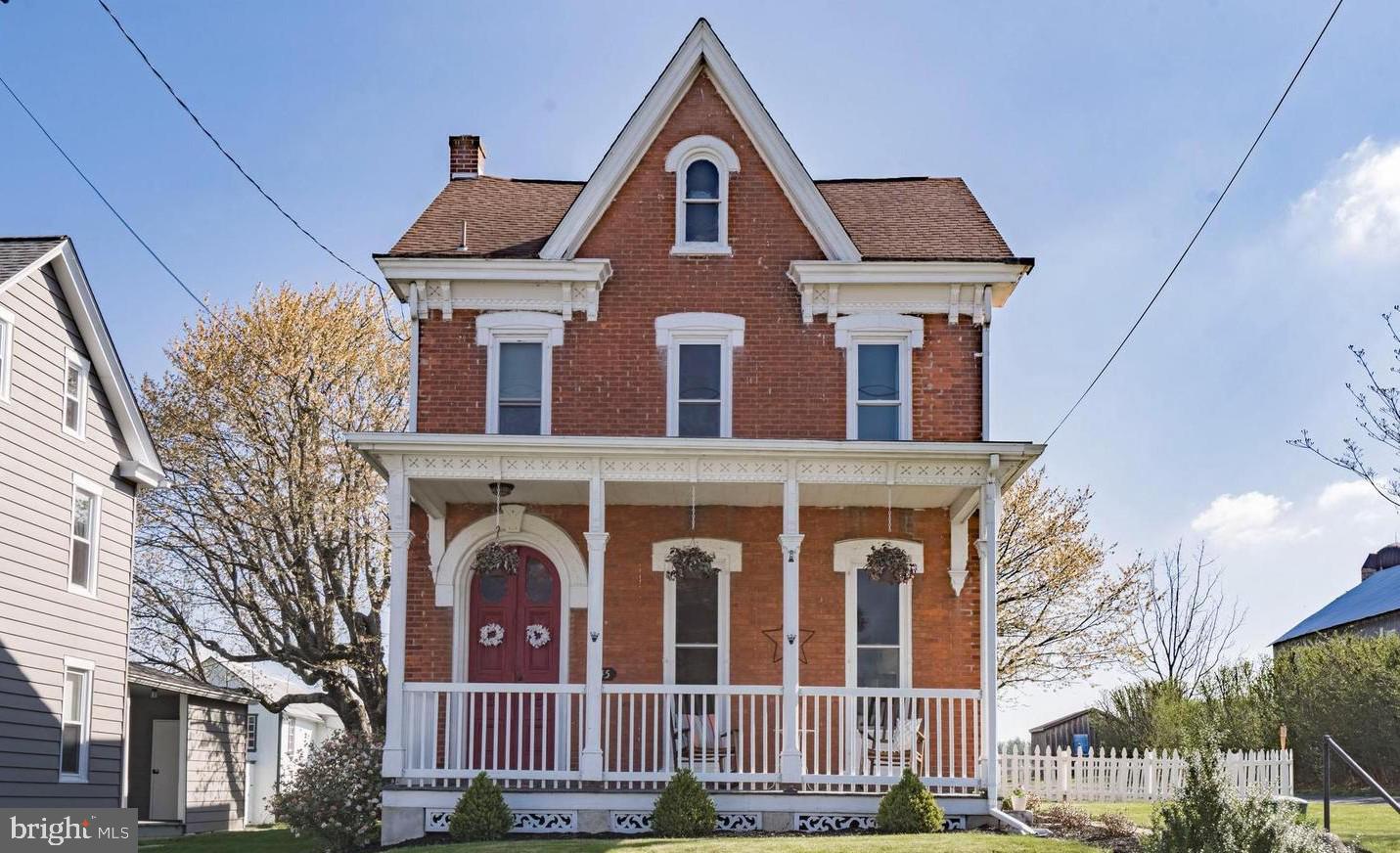 Welcome to 145 Hoffmansville Rd, where timeless Victorian character meets modern comfort. Built around 1900, this beautifully maintained brick home offers 3 bedrooms, 2 full bathrooms, and a convenient half bath, showcasing architectural details that are increasingly hard to find. From the soaring ceilings and intricate millwork to the oversized windows with deep sills, multiple inviting porches, and a hidden secondary staircase, this home is filled with distinctive charm at every turn.

Thoughtful updates make everyday living effortless, including a renovated kitchen with granite countertops, a center island, subway tile backsplash, and recessed lighting. The spacious primary suite features a private balcony, an oversized walk-in closet, and a stylishly updated ensuite bath. Additional improvements include central air conditioning, public sewer service, and a newer roof (partially replaced in 2020), providing peace of mind for years to come.

Situated against more than 9 acres of picturesque countryside, this property offers a peaceful rural setting while remaining just minutes from the conveniences of town. Downtown Boyertown is only a 10-minute drive and offers charming boutiques, local restaurants, the Colebrookdale Railroad, the Historic State Theatre, museums, and art galleries.

Outdoor recreation and entertainment are also close by, with Hickory Valley Golf Club just 4 minutes away, Hickory Park in 5 minutes, the Gilbertsville YMCA in 8 minutes, Butter Valley Golf Course in 9 minutes, Green Lane Park in 10 minutes, and Maple Springs Vineyard in 11 minutes.

This exceptional home combines historic elegance, modern updates, and an unbeatable location. Don't miss the opportunity to make it yours—schedule your private showing today. As an added bonus, the seller is including a one-year home warranty at settlement.