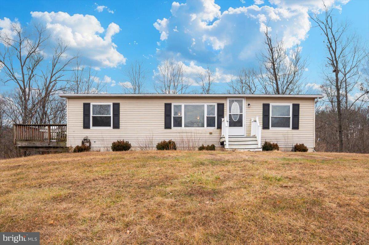Welcome to 105 Relative Way. This 3-bedroom, 2-bath manufactured rancher is situated on a private 2-acre lot backing to the woods in Falling Waters, WV, offering a quiet setting with room to spread out. The home features a practical one-level layout and a full unfinished basement that provides excellent storage, workshop space, or future potential. The property is affixed to a permanent foundation and offers the freedom of no HOA and low property taxes, keeping overall ownership costs low. Conveniently located just minutes from I-81 and the Maryland state line, the home provides easy access for commuters while still offering privacy and space. At this price point, it represents one of the most affordable single-family options currently available in Falling Waters. Property is being sold as-is. Schedule your showing to see the opportunity for yourself.