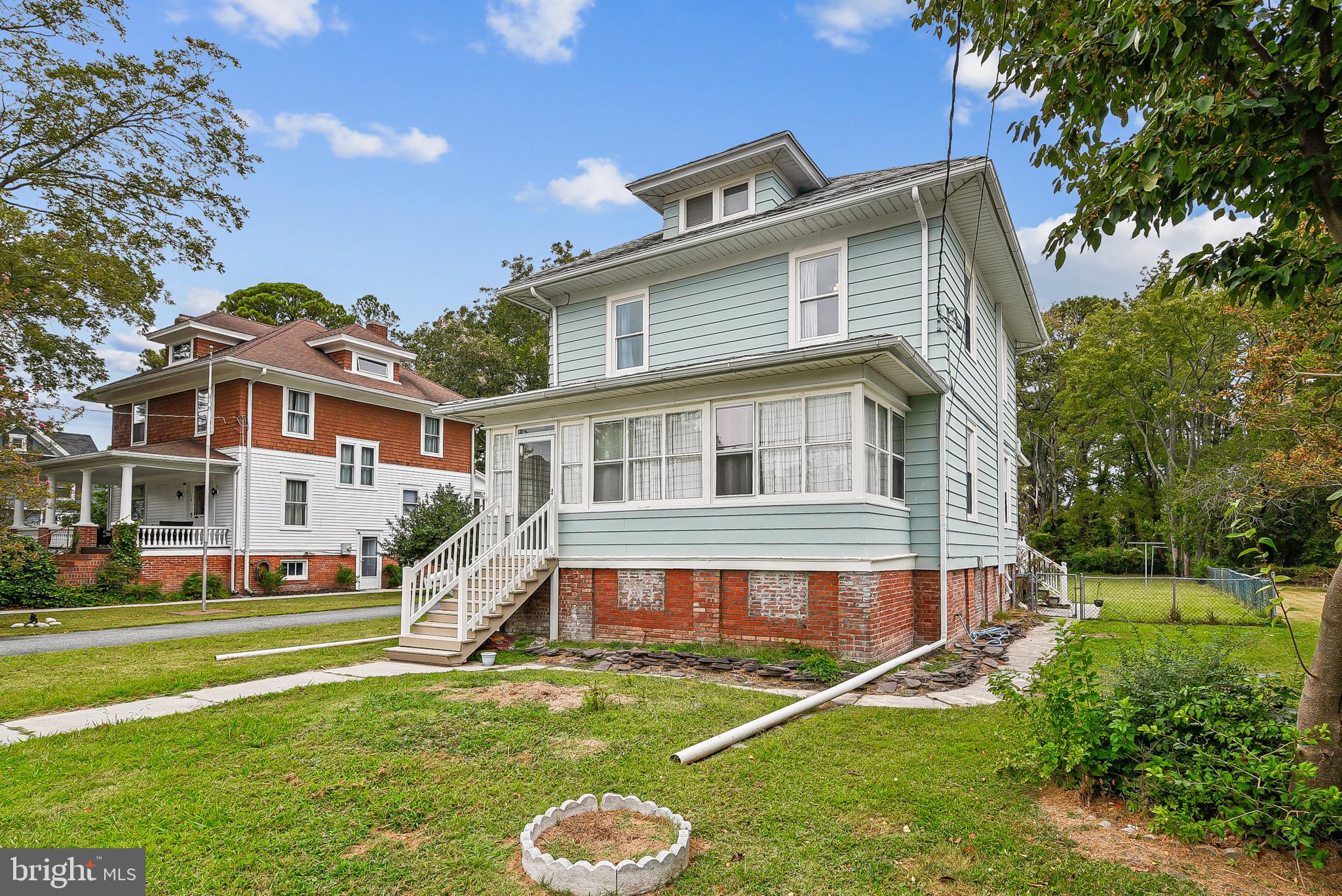 Welcome to a true classic in the heart of Crisfield, MD—104 years young and filled with charm! This timeless home has been thoughtfully updated to give you the best of both worlds: historic character and modern comfort. Inside, you’ll find hardwood floors throughout, a spacious living and dining room, a well-appointed kitchen, and 3 bedrooms with 2 full baths that provide plenty of space for family or guests.
The enclosed front porch/sunroom is heated and cooled so you can enjoy it year-round, while the large back deck is perfect for entertaining or relaxing outdoors. A sizable shed/workshop with 80AMPS Electric Service adds extra space for storage or projects. In the last 7 years, the Seller has invested in all the big-ticket updates for peace of mind—new HVAC system, updated electric, new insulation, new paint, new appliances, a sump pump in the crawlspace, a tankless water heater, updated bathrooms, and even a water softener system, just to name a few things! Plus, enjoy the convenience of city services with no worries about well or septic. This home is full of heart, character, and thoughtful upgrades—and waiting for you to make new memories! And when you’re ready to explore, enjoy all that Crisfield, Maryland has to offer—from world-class crabbing and fishing, to fresh seafood dining, boating, and breathtaking sunsets over the Chesapeake Bay. Please note, Buyers proof of funds or financing pre-approval must be submitted to the Listing Agent prior to showing confirmation.