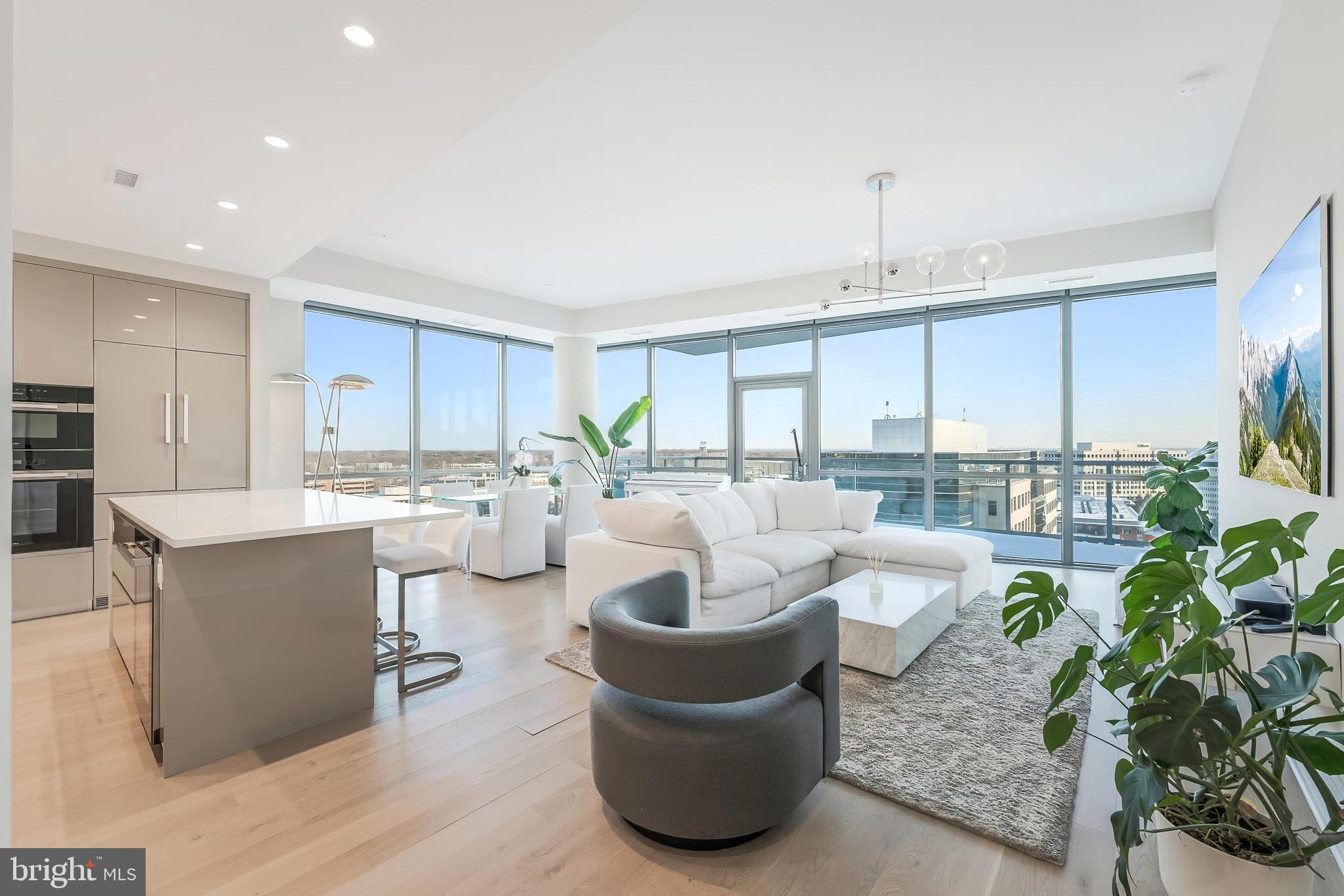 Three stories above the closest comparable unit, this exceptional residence offers unobstructed light, panoramic views, and a level of privacy rarely found in condominium living. Over $200,000 in elevated upgrades separate it from every other home in the building—both in function and finish, it stands in a class of its own.

Designed for modern living, the layout features a uniquely flexible second bedroom with two integrated Murphy beds, dual desks, and tailored shelving—transforming the space into a guest suite, office, or library with ease, eliminating the need for additional furniture. Custom millwork continues at the entry foyer with a built-in bench and coat storage, while the primary suite includes a bespoke dresser that seamlessly conveys.

Smart upgrades—solar-powered blinds, concealed TV and lighting wiring, RH fixtures, and an illuminated media console create a harmonious blend of architecture, technology, and comfort. The home also conveys with the building’s largest private storage unit (B10) and two side-by-side garage parking spots with EV charging (B112 & 113) 

Life at The Monarch is defined by service and amenities: 24-hour concierge, resort-style outdoor pool, fitness center, resident lounges, landscaped courtyards with fire pits, meeting rooms, and curated spaces for hosting and everyday living. It is McLean’s only full-service luxury condominium, delivering a sophisticated and effortless residential experience.