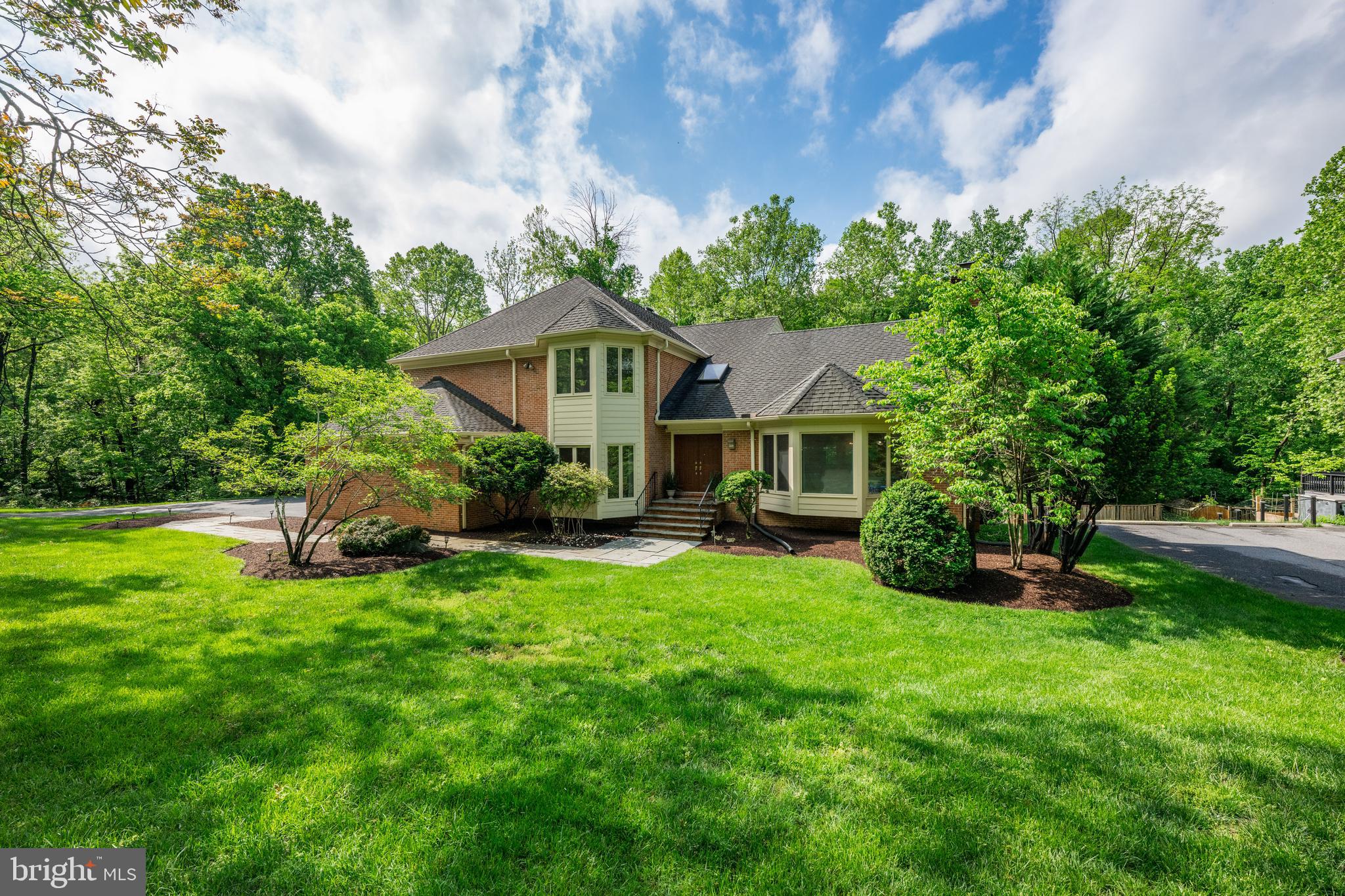 Wait until you see this incredible home! Over 6,700 finished square feet on three levels with soaring ceilings, expansive room sizes, and spectacular natural light--all set on a stunning half acre lot that backs directly to Great Falls National Park.  With easy access to the Billy Goat Trail and the C&O Canal, this is a dream home for the outdoor enthusiasts.  Tired of cookie-cutter colonials?  Get ready to be inspired.  This striking contemporary design offers a layout that just works - perfect for easy, everyday  living or entertaining on a grand scale.  Step inside and feel the difference immediately.  The Chef's kitchen is a dream come true, with exceptional storage and countertop space, opening to a dramatic family room with a floor-to-ceiling fieldstone fireplace and walls of glass overlooking protected parkland.  The spacious breakfast room also features panoramic views - truly a place to start your day!  A large main level study is great for working at home or it could easily become a first floor bedroom suite for an elderly parent.  Don't miss the oversized three-car garage with abundant storage.  Upstairs, the Primary Suite is a showstopper- cathedral ceilings, a wood-burning fireplace, and uninterrupted views of the treetops.  The luxurious marble bath includes double vanities, a soaking tub and walk-in shower for ultimate relaxation.  Three additional  large bedrooms and two full baths complete the upper level.  The daylight, walkout lower level is massive- finished with a recreation room, game area, exercise room, au pair suite and ample storage.  There's room to create your dream home theater or wine cellar if you wish.  The backyard is simply magnificent, a flat grassy area that blends seamlessly into parkland, and a huge deck perfect for outdoor entertaining, surrounded by mature, towering trees.  And the location?  UNBEATABLE! Minutes to the Clara Barton Pkwy, Potomac Village, the Beltway I-495, Tyson's Corner or north to the I-270 Corridor.  Commuting is a breeze!  Non-resident membership is available at the popular River Falls Swim & Tennis Club up the street.  Enjoy a lifestyle of nature and convenience, bike into Georgetown, kayak on the Potomac River or take a quiet stroll along the tow path.  This is low stress living at its best!  This home offers California-style living in one of Potomac's most special settings!  Come experience it for yourself.    Coveted Whitman School cluster, too!   WOW!