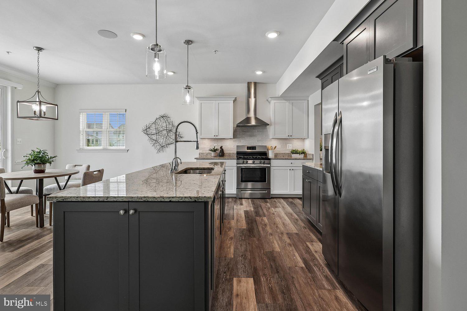 One of the largest models in the sought-after, amenity-rich community of Ellendale + one of the only basements on Kent Island, has just hit the market and it's sure to check all your boxes! Offering nearly 4,300 square feet, this impressive home features SIX spacious bedrooms, FOUR full bathrooms, and a convenient half bath on the main level. The upper level is designed with privacy in mind, featuring an expansive primary suite with dual walk-in closets and a large en-suite bath with dual vanities and a walk-in shower. A 2nd primary bedroom / Jr. suite and two additional bedrooms connected by a Jack and Jill bath means every upstairs bedroom has direct access to a bathroom. The English basement offers incredible flexibility with 2 additional large bedrooms, a full bath, a spacious family room, and a separate game room or den, making it ideal for guests, extended family, or entertaining. The heart of the home is the beautiful kitchen, complete with stainless steel appliances, an oversized island, and a butler's pantry featuring upper and lower cabinetry along with a beverage fridge, creating the perfect coffee or mini bar area. The kitchen opens seamlessly to the family room and casual dining space, while oversized sliding doors lead to a spacious deck overlooking the fenced backyard. At the front of the home, you'll find a private office and a formal dining room, perfect for working from home or hosting family and friends. Ellendale offers fantastic community amenities including a pool, tot lot, walking trails, and creek access for kayaking and other water activities. Conveniently located near shopping, waterfront dining, and just minutes from the Chesapeake Bay Bridge, you'll love everything Kent Island has to offer. Come experience the Kent Island lifestyle in this exceptional home.