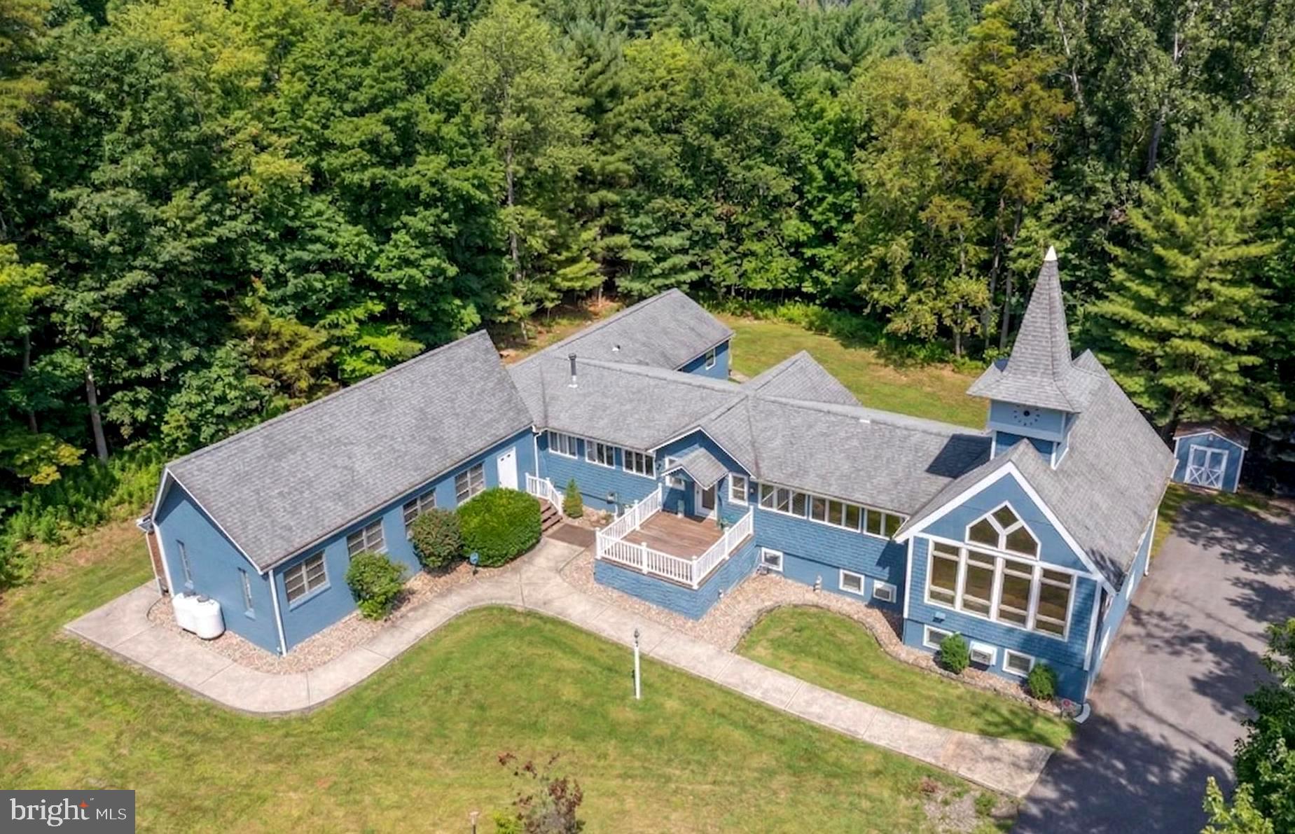 Iconic Lake Access Lodge at Carmel Cove – This one-of-a-kind property at Deep Creek Lake has 10 Primary Suites with an additional 2Bed/2Bath owner’s apartment on the lower level. Privately tucked away on 2 Acres of mature wooded land, you get the secluded feel of a personal mountain retreat with all the comforts of home! Featuring a massive great room with vaulted ceilings, timber accents, and an abundance of natural light. Fully renovated modern kitchen with granite tops, stainless appliances, and butcher block island bar. Breakfast nook on the way to the dining hall with its own stacked stone fireplace, coffee bar, and a wall of glass to let in the surrounding natural beauty. Covered porch off the main living area with private space on the wrap-around deck for each of the main level suites. The peaceful wooded setting for the bonfire pit. The convenient path down to your assigned Dock Slip is right next to the swimming platform in a no-wake cove. A well-established vacation rental, “Carmel Cove” has consistently averaged $100K+ annual rental income (between $100k-$140k over the last four years)! The sky is the limit for any future owner of this phenomenal lake access estate.  Call today for details!