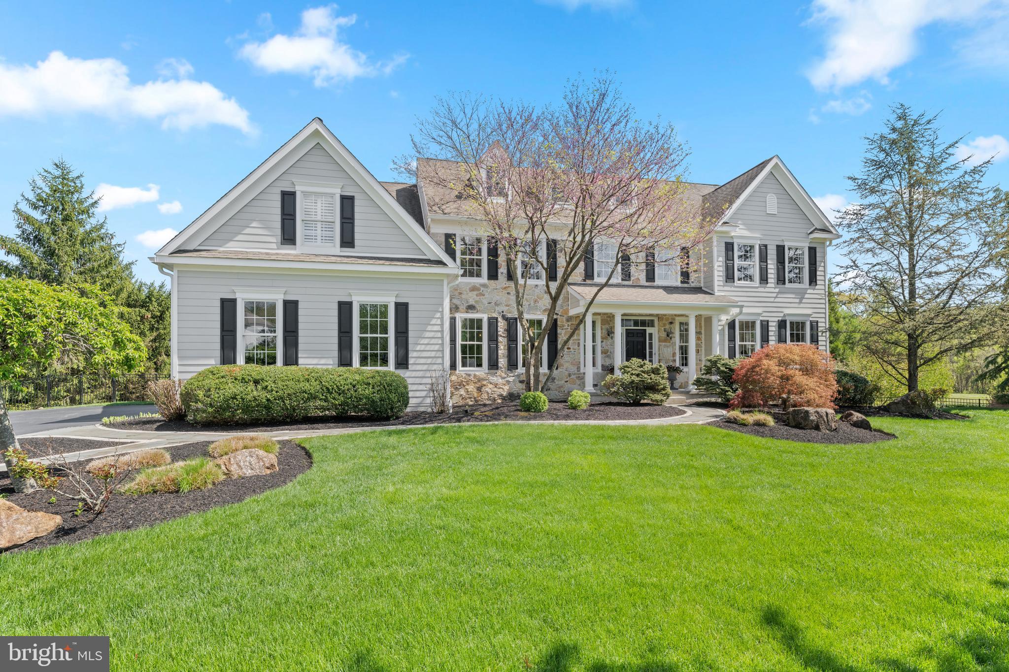 Welcome to 56 Lily Pond Lane, an updated stone and Hardie plank colonial tucked on a quiet cul-de-sac in the coveted Stonecroft neighborhood. Set on one of its most private lots, this 5-bedroom, 4 full and 1 half bath home offers breathtaking views of protected open space and blends timeless elegance with modern luxury across three beautifully finished levels.

Step through the front door into a dramatic two-story foyer anchored by a curved staircase, where sight lines carry straight through to the preserved landscape beyond. Rich hardwood floors flow throughout the main level, where a versatile layout offers something for every occasion. To the right, the formal living room showcases impressive millwork. To the left, the dining room connects to the kitchen through a classic butler’s pantry. At the heart of the home, the renovated kitchen features crisp white cabinetry, a generous center island, stone countertops, stainless steel appliances, and a walk-in pantry. It opens to a sunlit breakfast room and a family room crowned by a vaulted ceiling and warmed by a gas fireplace, all flooded with natural light and framed by those beautiful views. A separate living area with exposed wood beams and French doors offers a quieter retreat when you need it. Completing the main level: a laundry and mudroom, powder room, and interior access to the three-car garage with EV charging.

Upstairs, a catwalk overlooks the family room below and leads to the primary suite, a true retreat with a tray ceiling, sitting area, and two custom walk-in closets. The spa-inspired primary bath has been stunningly renovated with heated floors, custom solid walnut wood cabinetry topped with molded concrete countertops, a walk-in steam shower, freestanding soaking tub, dual vanities, and a private water closet. Three additional bedrooms include one with an ensuite bath and two connected by a Jack and Jill bath with double vanity. All upstairs bedrooms feature plantation shutters, ceiling fans, and brand-new upgraded neutral carpet.

The renovated walkout lower level lives like a second home, with wide-plank wood-look flooring that brings warmth and character to the space, a stylish bar and kitchenette with quartz counters and dishwasher, a media area with gas fireplace, and generous room for recreation. A bedroom and full bath make this level ideal for guests or multi-generational living. An additional room with French doors and a closet works beautifully as a gym, office, or potential sixth bedroom.

Outside is where this home truly sets itself apart. A deck with updated cable railing features a dining area with privacy trellis and built-in hot tub, overlooking a stunning pool with a waterfall, a stream leading to a koi pond, and a stone patio with firepit and Brazilian wood arbor. A second stone patio off the lower level expands the entertaining space and seamlessly connects to the pool area. The yard is expertly landscaped, fully fenced, and includes a large flat lawn perfect for soccer, wiffle ball, or cornhole, all framed by the serene preserved landscape beyond.

Walk to trails at Natural Lands’ Bryn Coed Preserve, and enjoy local favorites like The Birchrunville Store Café, Butterscotch Pastry Shop, Life’s Patina Mercantile, and Ludwig’s Grill and Oyster Bar, all within the award-winning Owen J. Roberts School District, recently recognized among the best in Pennsylvania.