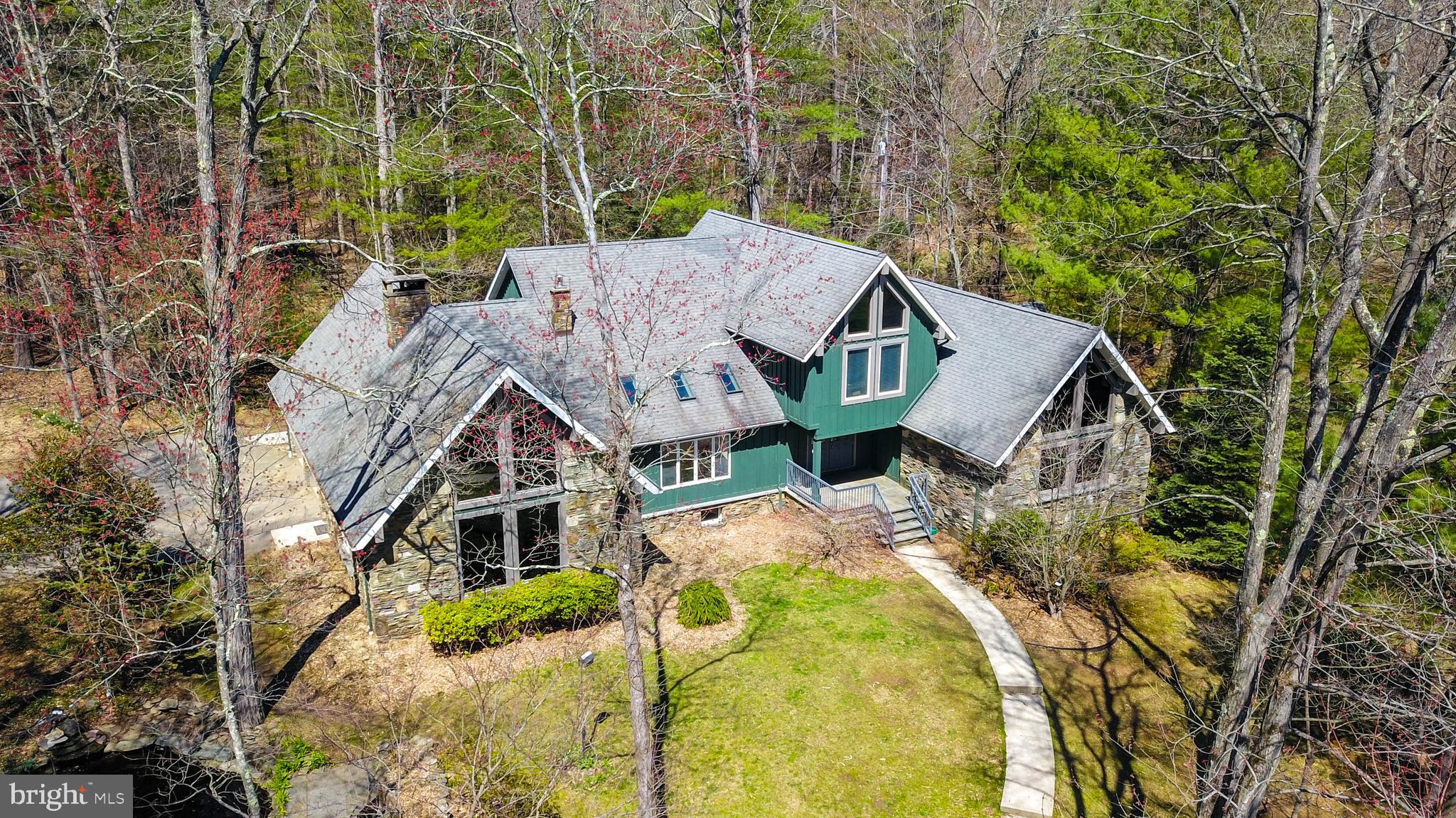 Are you looking for the perfect place to build your next project?  Look no further!  Currently a private estate w/ all the comforts of luxury living. This chalet is tucked on 52-acres and sure to enchant.  And there are 52 acres of land, Approx  35 acres are cleared, pastured or tilled for easy building.  Sitting serenely at the end of a long, gated driveway thru park like woods lies nearly 5k sq ft of home w/ 5BR, 3BA's.  Vaulted ceilings & large windows, well appointed kitchen, master suite, multi family option.   Sunken family room w/ floor to ceiling windows offering amazing views & a stunning stone fireplace.   A full main floor master suite wing with soon to be replaced flooring!  Up to the 2nd floor via interior stairs or private back door entry, you’ll find uniquely designed & spacious bedrooms & another large living area - play room, in law quarters or whatever your imagination can create! Outside find a horse/animal pasture w/ run-in, fenced Hay Pasture, & animal Barn w/ electric  fence, hay barn, shed, & 2 ponds.  Use the land productively for farm income,  subdivide and build housing, or just have your own private fortress of tranquility.  Currently, Low Act 319 taxes that could be converted if subdividing is your choice.  Cable, Cell Service. Nestled in the foothills of the Poconos & easy access to NYC/NJ make this property even more desirable!