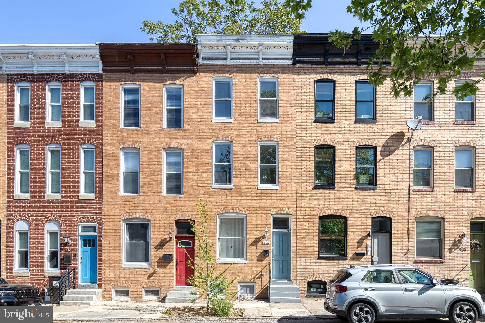 PRICE IMPROVEMENT!  *Preferred lender can provide $5,250 grant to eligible buyer - reach out to listing agent for more information* Exceptional Properties. Exceptional Clients. Welcome to 422 E Lanvale Street – a beautifully maintained rowhome in the heart of Greenmount West, one of Baltimore’s most vibrant and artistic communities. This spacious home blends historic charm with thoughtful updates, including natural hardwood floors, fresh paint throughout, tall ceilings, and abundant natural light throughout. 
The main level features a comfortable living area, dining space, an updated kitchen with stylish countertops and ample cabinetry, a full bathroom, and a main-level bedroom with direct access to the private, fully fenced backyard—perfect for relaxing or entertaining.

The second level offers one spacious bedroom, a full bathroom, and a large additional living room area—ideal for a home office, media room, or lounge. The third level includes two nicely sized bedrooms and another full bathroom, offering flexibility for guests or creative use. The unfinished basement houses the laundry area and plenty of storage space. Recent updates include a newer water heater and updated outdoor air conditioning unit, offering peace of mind and energy efficiency.

Enjoy walkable access to Station North, Penn Station, Mount Vernon, and local galleries, cafes, and restaurants. Don’t miss your chance to own this light-filled and versatile home in the heart of Greenmount West!