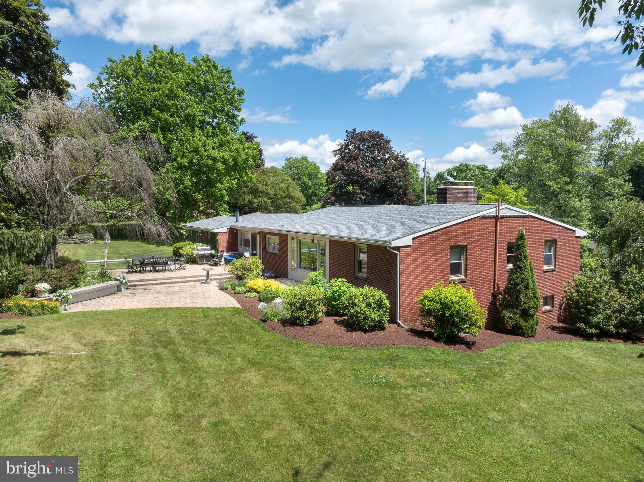 Welcome to this well-maintained 3 bed, 2 bath Mid‑century home tucked away in a fantastic location, with the newly expanded Mount Nittany Elementary just moments away. This is an excellent opportunity for true one‑floor living, offering a flowing floorplan and bright, open spaces throughout! A desirable main‑floor primary bedroom adds everyday convenience. The dining room, kitchen, and breakfast area overlook the gorgeous multi‑tiered garden, backyard patio, and mature trees. A stylish full bath features upgraded countertops, dual sinks, and a tiled walk‑in shower. The living room is anchored by a cozy wood‑burning fireplace and a large picture window framing beautiful views. You’ll appreciate the generous pantry closets and the main‑floor office with built‑in desk and shelving—perfect for a work‑from‑home setup or creative hobbies. The finished lower level provides an expansive family room with integrated shelving, a gas fireplace, and abundant natural light. An oversize walk‑in closet offers excellent storage. A Jack‑and‑Jill bath connects the two lower‑level bedrooms, and an additional storage room houses utilities and laundry. A second laundry hookup is also available in the main‑floor office for added flexibility. Privately tucked away yet close to everything Boalsburg and State College have to offer, this home blends comfort, convenience, and a truly special setting.