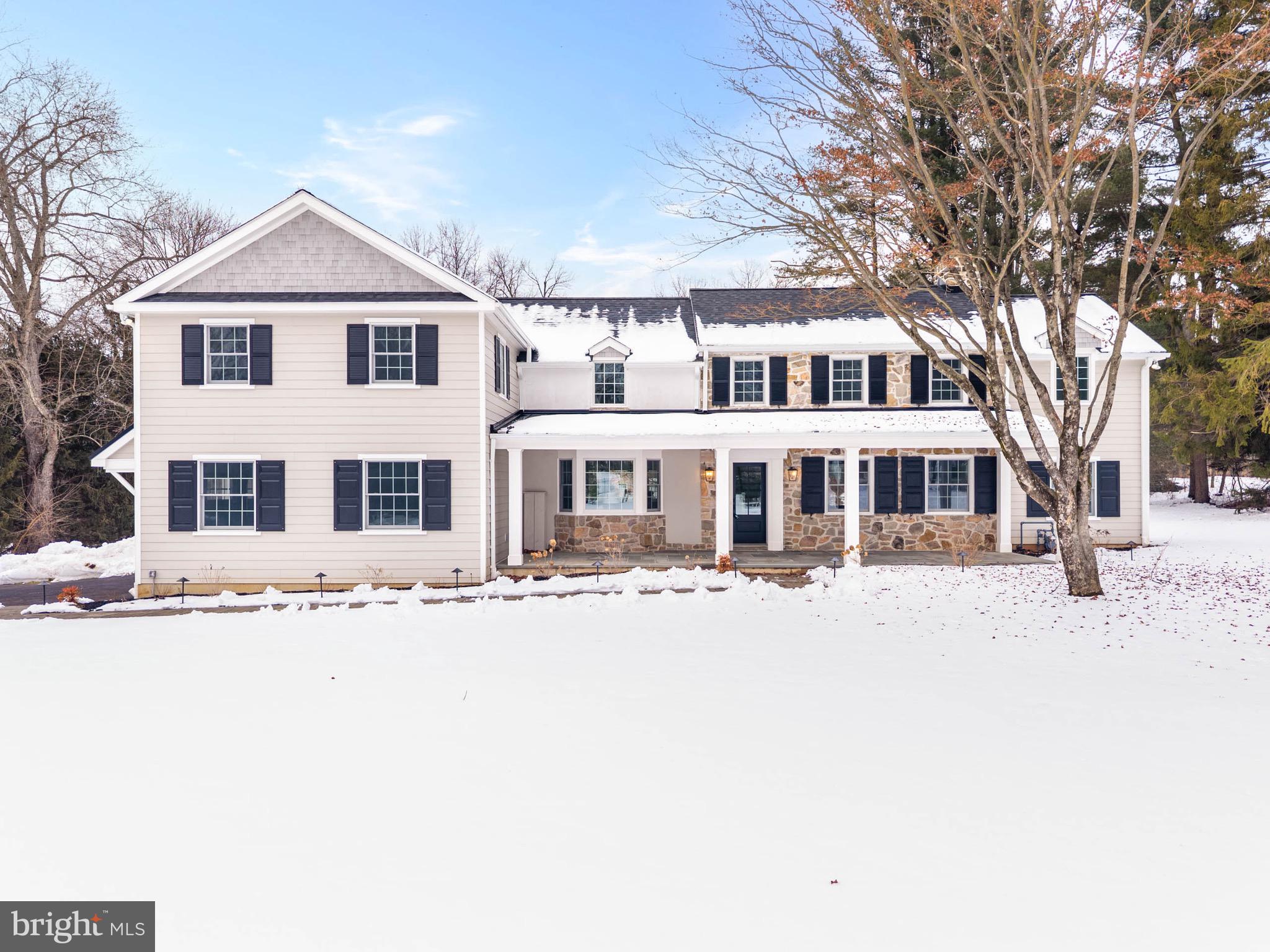 For those seeking uncompromising design and craftsmanship without the timeline of new construction, this reimagined custom residence by MP Renovations, in collaboration with Foley Hillestad Architecture, offers an unrivaled blend of modern sophistication and timeless character. Positioned on 1.44 level acres in Easttown Township, the property presents a rare opportunity to enhance the grounds with a detached 2+ car garage or pool and guest house. The flagstone front porch opens to light-filled interiors, where finished natural oak floors extend throughout an expansive, well-proportioned open floor plan, defined by exceptional attention to detail. To your left, the family room connects seamlessly to a gourmet kitchen appointed with premium appliances, abundant white cabinetry and refined finishes. The 10-foot quartz island anchors the space with generous seating and serves as the natural hub of the home, allowing everyday living and entertaining to unfold with ease. Just beyond the kitchen, a brick-floored mudroom introduces warmth and texture, complete with built-ins, coat closet, a pantry and a powder room. A door leads to a flagstone patio, ideally positioned for grilling, just steps away from the kitchen. The mudroom also provides easy access to the attached two-car garage. To the right of the front door, the formal dining room is distinguished by its fireplace, creating an elegant setting for gatherings of any size. A private study sits just off the dining room, where built-ins and an exposed stone accent wall add richness and architectural interest. The luminous living room, framed by wall-to-wall windows, features a fireplace, built-in wet bar and flows easily to both the kitchen and dining room. Doors open to a flagstone patio overlooking the backyard, well suited for outdoor dining and relaxation. The center hall staircase leads to the second floor. To the right, the primary suite unfolds as a private retreat, allowing a sense of separation and comfort, with large windows overlooking the property. A walk-in closet with built-in shelving and a luxurious bath with dual vanities, a soaking tub and a frameless glass shower establish an atmosphere of understated distinction. Four additional bedrooms complete the second level, each with well-scaled closet space. One bedroom includes an ensuite bath, another is located directly across from a full hall bath with a tub, while the remaining two share a Jack and Jill bathroom. A laundry room with cabinetry and a sink and a linen closet are in the hallway as is the back staircase. The finished lower level offers versatile space suited for a home gym, yoga room, or recreation area, along with a powder room, and storage space. The home’s mechanical systems are housed here as well. A dedicated wine cellar, defined by exposed beams, a stone accent wall and a flagstone floor, evokes old-world character and craftsmanship, appealing to the true wine enthusiast. Located within the award-winning Tredyffrin Easttown School District and in close proximity to some of the region’s most respected private schools, the home enjoys easy access to major commuting routes, renowned golf clubs, acclaimed dining and premier shopping. An exceptional offering in Easttown Township. Private appointments available.