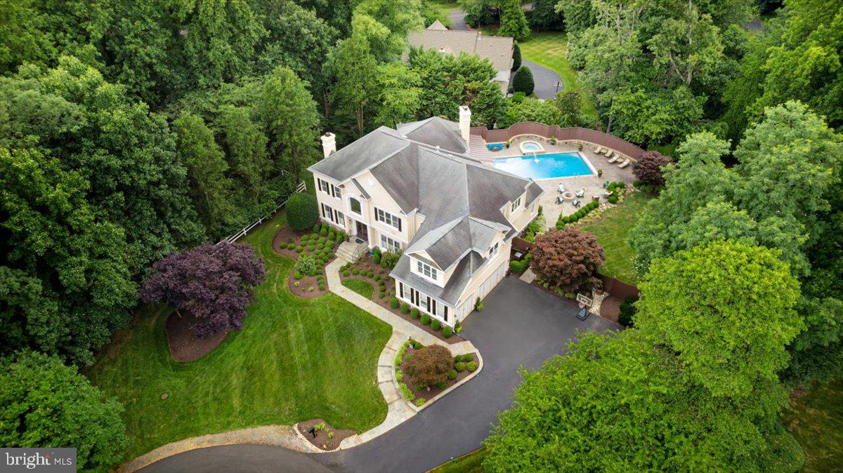 If outdoor living is your priority, this is the home for you!!  This is a WOW lot. Oakton, VA is a charming suburban community in Fairfax County. It is known for its excellent schools and proximity to Washington, D.C. This area offers a blend of suburban tranquility and urban convenience, making it an ideal home and real estate investment.  This expansive retreat on Sarah Joan Ct is quintessential Oakton! Imagine taking a dip in your heated pool, then turning on the TV inside the pergola while you make dinner on the outdoor grill.  Listen to the crickets and birds chirping on one of the quietest lots you can find in Northern VA.  Welcome to this exquisite estate in Oakton, VA, feeding to the Oakton High School Pyramid. Situated on a .83-acre lot, this home has a glistening pool, hot tub, outdoor grill, updated pergola, a perfectly flat yard with lush landscaping, and a serene spot for relaxing in Adirondack chairs on a summer night.
You will find an entertainer's dream layout on the main level, from the kitchen to the restaurant-style bar area to an expansive room for watching movies or sporting events. It also houses a pool table, bar-style seating, and windows galore.  Each of the four bedrooms is full of space and sunlight on the upper level.  The classic primary suite is outfitted with office space, a seating area by the fireplace, a dressing room, two walk-in closets, and a perfectly designed spa-like bathroom.   The lower level has all the finishing touches.  A true home gym, theater area, full bathroom, guest rooms, and tons of storage complete this magnificent estate. With quality renovations, stately details, and refined finishes, this home offers an opportunity to own a masterpiece tucked away at the end of a beautiful street.