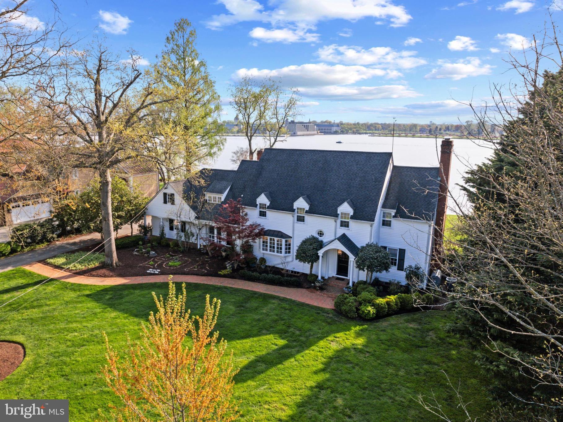 Charming storybook home with enchanting panoramic waterfront views will make you feel like you are living a fairytale everyday! Built by a well-known navy admiral, this elegant  home was one of the last significant waterfront residences to be erected prior to World War II. The homes along the coveted Homewood Road are effectively known as the sea captain homes and are reminiscent of a bygone era. Designed to maximize the views and perfectly elevated to overlook all the coveted landmarks that make Annapolis special right from your backyard or from almost every room in the house. The expansive brick patio, level backyard with lush lawn and beautiful landscaping is the perfect setting for hosting parties big and small; gaze out at the Naval Academy, enjoy the night time glow of downtown Annapolis all year round and savor the front row seats for the endless activity on the Severn River including the amazing acrobatics of the Blue Angels. Inside, the home exudes charm and impresses with the detailed moldings, wainscoting, fireplace surrounds, wood floors and curated finishes. The formal Living room, Dining room and Family room on the waterside of the home all feature large windows to allow the light to pour in and to frame the spectacular views across the Severn River. The spacious Kitchen with large island is sure to be the favorite gathering place and the heart of the home. The primary bedroom suite occupies an entire wing of the upper level featuring vaulted ceiling, fireplace, skylights, spa-like bath, enormous custom closet and awe inspiring panoramic views across the Severn River.  The additional 3 bedrooms, including a secondary primary suite with ensuite bath provide plenty of accommodations for family and friends.  Nestled between 2 bedrooms is a quaint office space with water views and the stairs leading to the finished attic space. Head out for a day on the water from the deep water dock (8ft MLW) with boat lift, great location for easy access to the Annapolis Harbor, Chesapeake Bay and beyond. Annapolis waterfront living at its finest. Welcome Home!