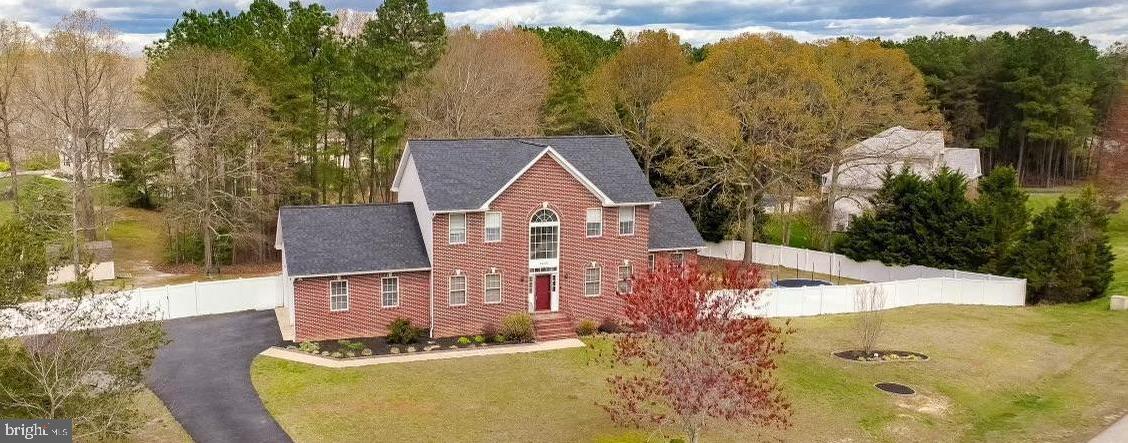 Welcome home! Step into this inviting 6-bedroom, 3.5-bath Colonial, perfectly situated on a quiet cul-de-sac and nestled on a beautiful 1-acre lot. Complete with a spacious two-car garage and a large fenced backyard, this property offers the ideal setting for outdoor enjoyment, family gatherings, and pets to roam safely. From the moment you arrive, the charming brick-front exterior and welcoming curb appeal set the tone for everything this exceptional home has to offer.
Inside, you’ll find an abundance of natural light throughout the thoughtfully designed floor plan. The main level features a private home office, formal dining room, spacious family room with a cozy fireplace, and a well-appointed kitchen with ample counter space, making everyday living and entertaining effortless.
Convenience continues with a main-level laundry room and direct access to the oversized two-car garage. Step outside onto the expansive deck overlooking the fully fenced backyard—perfect for relaxing, hosting guests, or simply enjoying the peaceful surroundings.
The fully finished walkout lower level offers incredible flexibility with a second kitchen, private bedroom, and generous living space. Ideal for multigenerational living, extended family, adult children, guests, or potential rental income, this versatile area also provides plenty of room for a home gym, recreation room, or entertainment space.
Upstairs, you’ll find spacious bedrooms designed with comfort and privacy in mind, providing ample room for everyone to enjoy.
Additional updates include a newly installed roof and HVAC system in 2024, offering added peace of mind for years to come. Conveniently located with easy access to PAX River NAS, Joint Base Andrews, Washington, D.C., and surrounding commuter routes, this home combines a peaceful setting with an ideal location for work and everyday convenience.
Blending warmth, functionality, and versatility, this remarkable home is ready to welcome its next owners. Schedule your private showing today and experience all this wonderful property has to offer.