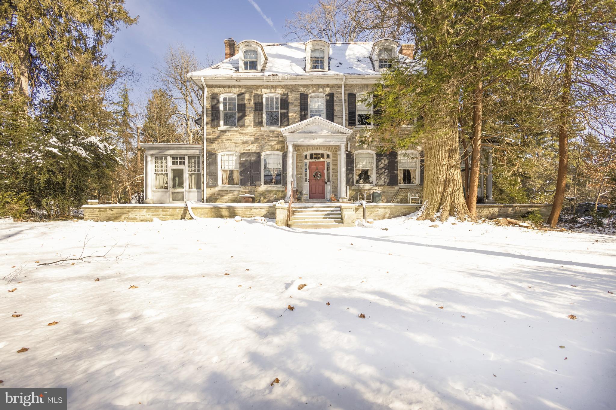 Experience the harmonious blend of history and grandeur in this distinguished 1886 Wissahickon schist Chestnut Hill classic, masterfully crafted by the renowned architect Horace Trumbauer for the esteemed Philadelphia philanthropist, Henry H. Houston. Known for his development of the Saint Martins section in the garden district, originally called Wissahickon Heights, Houston’s legacy echoes throughout this 6-bedroom, 4.5-bath residence. Marvel at the original hardwood floors, intricate millwork, and six stately fireplaces that narrate a tale of timeless elegance, all beneath soaring ceilings. Natural light bathes the living and dining rooms through two stunning solariums, while a gracious entry hall with a powder room anchors the main level. The adjacent kitchen retains historical charm, complete with an original butler’s pantry, epitomizing the quintessential Chestnut Hill design. Set on a serene, private lot, the mature gardens provide a peaceful retreat and enduring beauty. Situated on perhaps one of the prettiest blocks in Philadelphia, this home offers a perfect blend of seclusion and accessibility. It is walkable to the village, schools, trains and the endless footpaths of Valley Green—Fairmount Park’s crown jewel. Embrace the opportunity to breathe new life into this storied residence at 8221 Seminole, crafting your own chapter in its illustrious history, offering both a sanctuary and a gateway to the vibrant community.