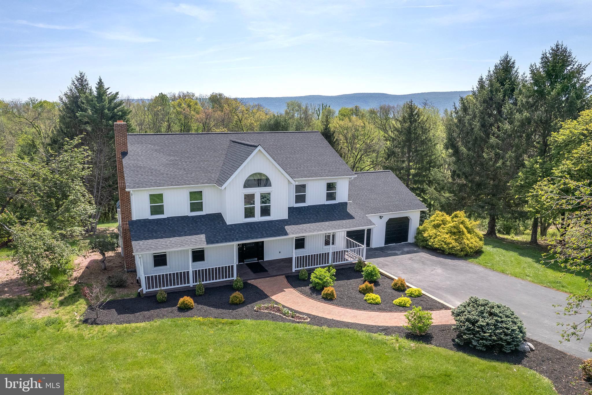 NEW PRICE REDUCTION !!
Meticulously Renovated Colonial on 2.15 Acres with In-Law Suite & Smart Features

Welcome to this exquisitely renovated 4-bedroom, 4.5-bath Colonial in the prestigious Spring Hollow Estates. Set on a private 2.15-acre lot, this nearly 5,000 sq ft residence blends timeless architecture with high-end modern upgrades—just a couple minutes from I-81 and the vibrant town of Woodstock.

Renovated to an exceptional standard, this home features hardwood flooring across all three levels, elegant tilework, custom millwork, and refined lighting throughout. The main level includes formal living and dining rooms with crown molding and chair rail, a sunlit living room centered around an unused brick fireplace, and a designer kitchen with quartz countertops, smart stainless steel appliances, and abundant natural light.
Upstairs, the spacious primary suite offers a spa-like bath with a freestanding soaking tub, glass-enclosed shower, and marble-topped dual vanity. One additional bedroom includes a private en-suite bath, while two more bedrooms share a third full bath—perfect for family or guests.

The fully finished walk-out lower level features a complete in-law suite with a kitchenette, full bath with marble vanity, private laundry, and its own entrance—ideal for multigenerational living or flexible accommodations.

Step out from the family room onto a maintenance-free composite deck with peaceful easterly views. The backyard backs to mature woods and enjoys exceptional privacy with no neighbors on two sides.

Key Features and Recent Upgrades:

New energy-efficient windows throughout

New roof, heat pump, and water treatment system with two new hot water tanks

Smart switches, USB outlets, and Google Nest thermostats

Smart appliances and 4-camera Ring security system

Oversized 2-car garage with new garage door opener and decorative flooring

Extensive mechanical improvements throughout

This move-in-ready home delivers space, quality, and smart living in one of Woodstock’s most desirable neighborhoods