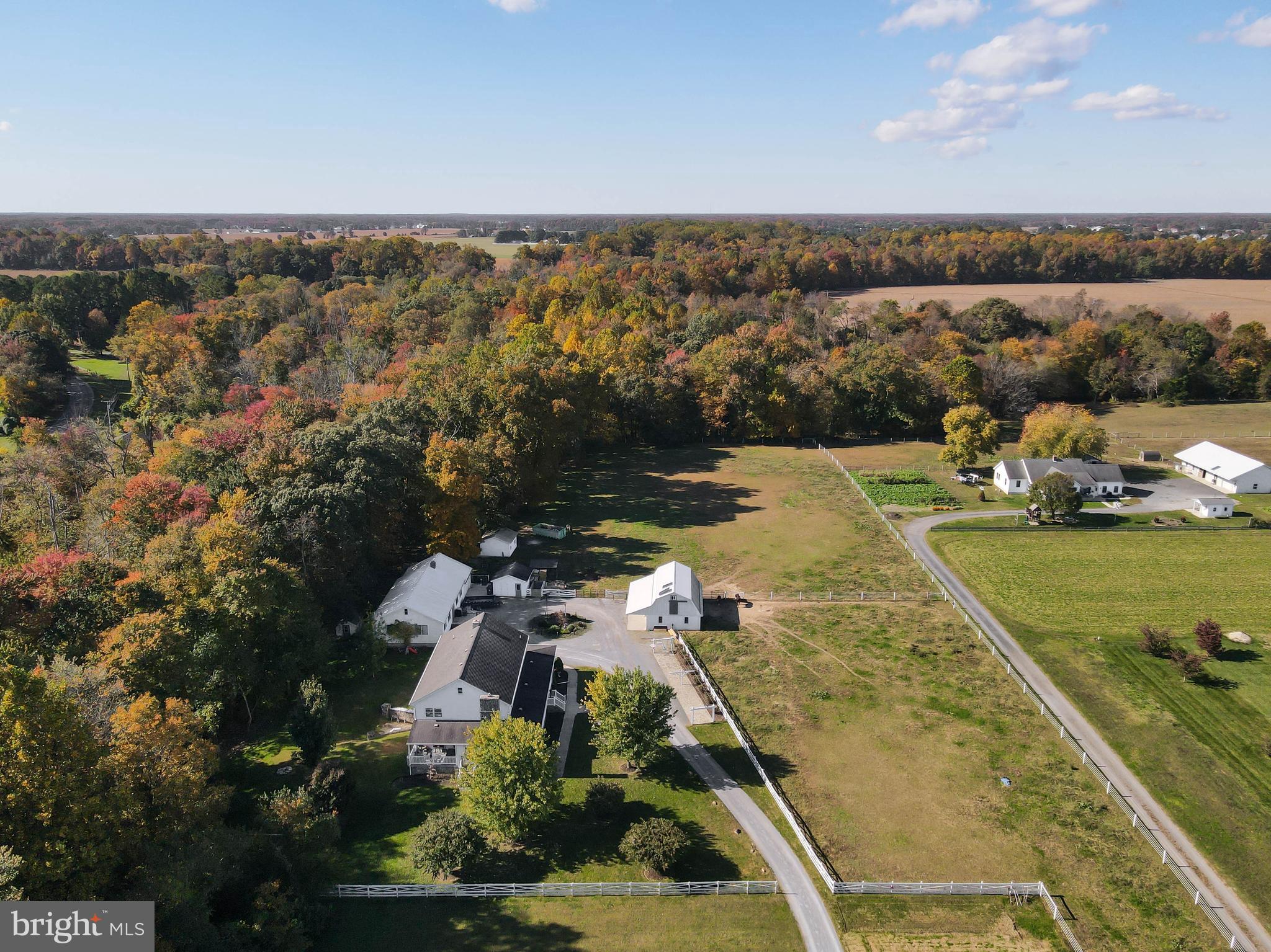 Discover this rare 7-acre farm and residential property at 109 Apple Grove School Rd, Camden, DE, offering a quiet country retreat with two separate homes and extensive equestrian facilities.

The Amish-built main farmhouse features true main-level living with a spacious bedroom and hall bathroom, alongside a large kitchen boasting a gas stove and custom Amish cabinets. The main floor showcases hardwood floors, a mudroom entry, and a sunroom with linoleum. The family room includes a fireplace that currently has a propane insert, offering the flexibility to be converted back to a traditional wood-burning fireplace or install your choice of insert. Upstairs, find four spacious bedrooms, a full bath with Corian counters, an extra flex/sewing room, and an unfinished walk-up attic.

The home also includes an unfinished walk-out basement and is finished with front and back composite sitting decks. The basement also has a boiler fireplace that is used to heat the home. The property utilizes coal heat, and the seller will install electric heat if desired, supported by Messina HVAC (note: Central AC is not currently present). The property includes an additional storage building that includes a bathroom and an attached two car garage.

Equestrian amenities include a 24x36 barn with three box stalls and a tie stall, plus two separate fenced pastures and an outside freeze hydrant. Ample storage is provided by three sheds, including two measuring 20x20. Located near the town of Camden and the capital city of Dover, you enjoy easy access to dining, shopping, and healthcare, with Delaware's beaches just a short drive away. This property is perfect for multi-generational living or an income-producing opportunity.
