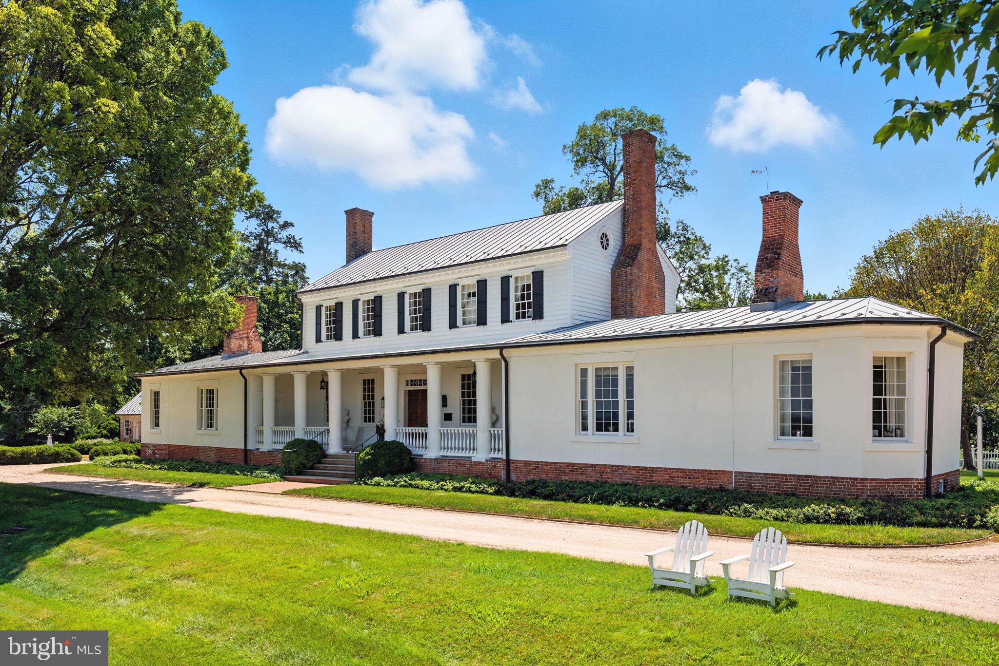 ROSE HILL ESTATE — 352 ACRES OF HISTORIC ELEGANCE AND AN ELEVATED COUNTRY LIFESTYLE
Featured in Architectural Digest, this Amelia T. Handegan–designed residence anchors one of Virginia’s most distinguished country estates. Encompassing 352.24 acres, the property offers timeless elegance, masterful restoration, and unparalleled privacy. Designed for those who value both heritage and luxury, every detail reflects refined craftsmanship and enduring beauty. The estate’s remarkable grounds and gardens were further recognized with the 2016 ASLA Virginia Chapter Merit Award, honoring the property’s exceptional landscape architecture and stewardship.

Protected under conservation easement, the estate’s rolling landscape unfolds through two gated entrances across open fields, century-old hardwoods, formal gardens, and a stocked pond—offering a rare balance of seclusion, scale, and natural beauty.

Originally built in 1799, the residence was comprehensively restored in 2011 by Tidewater Preservation, Inc., under the direction of acclaimed Charleston designer Amelia T. Handegan. The result is a seamless blend of historic integrity and modern sophistication, enhanced by geothermal climate control and radiant floor heating.

The 5,431-square-foot main residence features 4 bedrooms, each with an ensuite bath, and a collection of gracious living spaces defined by hardwood floors, intricate crown molding, chair railing, and custom French wallpaper. Formal rooms include a dining room with fireplace, an elegant living room with built-ins, and a distinctive octagonal music room with English windows and hand-painted geometric floors.

The chef’s eat-in kitchen pairs historic character with professional-grade function, offering custom wood cabinetry, a wood-burning fireplace, marble-topped island, Wolf range, paneled appliances, wine refrigerator, and ice machine. A well-appointed mudroom with built-ins and laundry provides convenient access to the gardens.

The main-level primary suite is a private retreat, featuring a fireplace, sitting room with built-ins, walk-in closet, and direct access to the outdoors, along with a marble-clad bath complete with dual vanities, soaking tub, and walk-in shower. Additional bedroom suites offer fireplaces, built-ins, and beautifully appointed baths, each capturing sweeping views of the rolling countryside, pond, or historic gardens.

Beyond the main residence, a guest cottage with exposed beams, marble finishes, and a fireplace offers refined accommodations for visitors. A Pennsylvania bank barn, relocated in 2009, has been thoughtfully reimagined to include a gym, office with full bath, and loft. Distinctive architectural elements include a Thomas Jefferson–inspired dovecote with Birmingham Rollers and a newly constructed folly overlooking the pond.

Outdoor amenities are equally exceptional, featuring a tennis court with pavilion, croquet lawn, riding trails, and formal gardens that have been showcased in Garden Club tours, filled with hydrangeas, peonies, fruit trees, and rose of Sharon. A working barn supports a herd of Belted Galloway cattle, further enhancing the estate’s pastoral character.

Utilities include well water, septic, geothermal HVAC, propane heat (two owned tanks: 500 and 1,000 gallons), radiant floor heating, and four hot water tanks.

A rare and significant offering, Rose Hill Estate embodies a legacy property—where history, land, and lifestyle converge in extraordinary form.