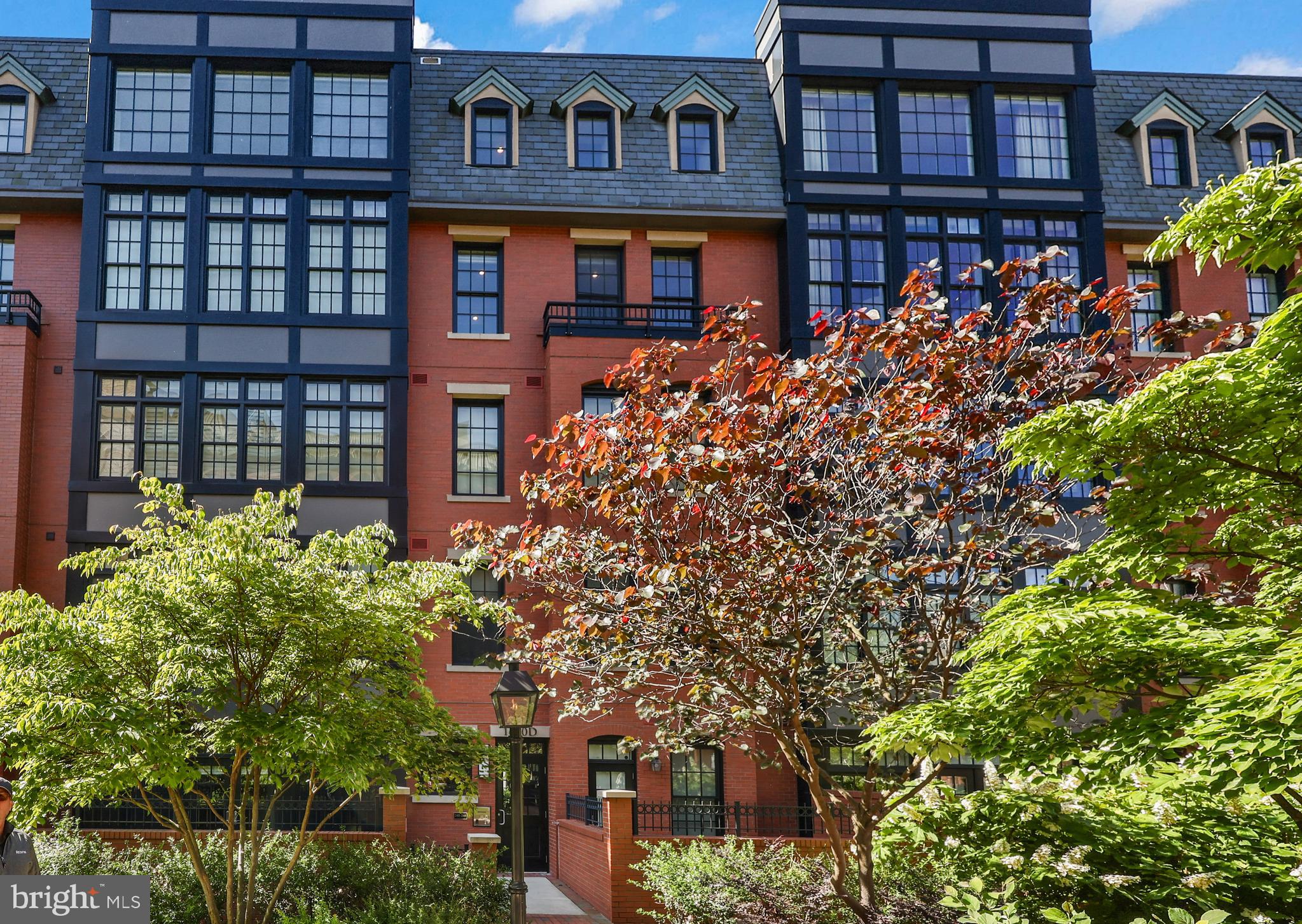 Welcome to 1610 N Queen St at Gaslight Square, a spacious two-level penthouse offering 1,882 square feet of luxury living nestled between Rosslyn and Clarendon. This exceptional residence features direct elevator access, an open-concept floor plan, soaring 18-foot ceilings with LED lighting, hardwood floors, and a private rooftop terrace. The gourmet kitchen features premium Wolf and Sub-Zero stainless steel appliances as well as additional cabinetry added in 2025 to expand storage. The main-level of this home features the first of two primary bedrooms with an ensuite bathroom and a beautifully appointed walk-in closet.  Also on the main level, you will find a powder room for guests and a laundry room with a front loading washer and dryer. The upper-level includes a large loft space ideal for an office and/or secondary living room as well as the second primary bedroom with an ensuite bathroom and walk-in closet. From this level you will also access the private rooftop terrace providing the perfect setting for outdoor entertaining, gardening, or simply relaxing. Two tandem parking spaces in the secure underground garage with direct elevator access add to the home's exceptional convenience.  Ideally situated less than half a mile from both the Rosslyn and Courthouse Metro stations, Gaslight Square offers unparalleled access to shopping, dining, and everyday conveniences. Georgetown is just one mile away across the Key Bridge, while the dynamic Rosslyn-Ballston Corridor provides an abundance of restaurants, entertainment, parks, and recreational opportunities. The building will be upgrading its front door entry system to ButterflyMX system in June.  Combining luxury finishes, exceptional outdoor space, and a premier location, this residence presents a rare opportunity to experience sophisticated penthouse living in one of Northern Virginia's most desirable urban communities.