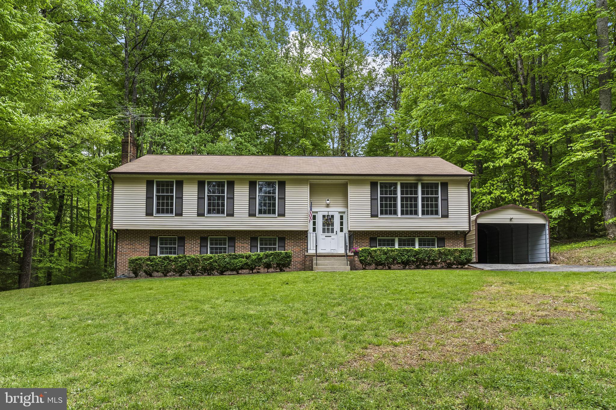 "Rare "7+ acre opportunity in sought-after Wilkerson’s Inheritance—larger than most homesites in the community! Enjoy privacy, wildlife, and endless potential to create your own retreat.

This split foyer home offers a functional layout with multiple living areas and generous room sizes, ready for your personal updates and vision—and priced accordingly.

The main level features a spacious living room, dining area, and kitchen that flows into a picturesque sunroom overlooking gorgeous azaleas and a majestic wooded backdrop filled with birds, deer, and other wildlife. The expansive primary bedroom offers both front and rear views of the property, along with a large walk-in closet, double sink vanity, and a private water closet. Two additional bedrooms are well-proportioned and share a full hall bath.

The lower level offers additional living space, complete with a bedroom, a full bathroom and a large laundry area, along with flexible space ideal for a recreation room, complete with wood burning stove, guest area, home office, hobby or project space, or seasonal storage.

The outdoor space is where this property truly shines. A concrete pad with a garage-style storage structure provides the perfect space for lawn equipment, gardening tools, or outdoor toys—complete with electricity and nearby water access. A second concrete pad offers endless possibilities, ideal for a basketball hoop, additional storage building, or hobby space.

A flat, dedicated garden area is ready for growing fruits and vegetables, or could easily be transformed into a play area, entertaining space, or even a future pool site.

With solid bones, expansive usable land, and incredible flexibility, this property is a unique opportunity for buyers looking to create their own private retreat. Conveniently located with access to commuter routes, shopping, and amenities—all within an easy commute to Washington, DC, Pax River, and Andrews AFB."