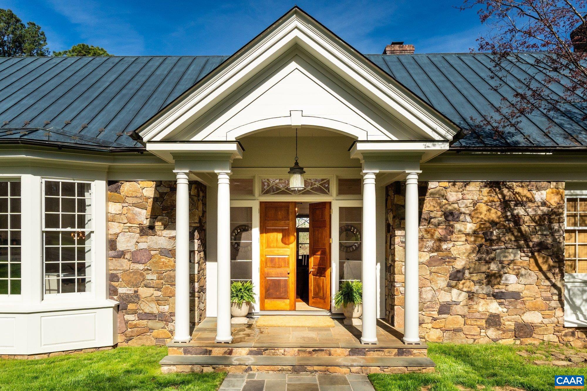 Just off Garth Road and minutes to town, this custom-built home offers sweeping mountain and pastoral views overlooking the protected 175 acres of Foxfield. Built with exceptional craftsmanship, the residence spans approximately 5,500 finished square feet with 4 bedrooms and 6 baths on 5.65 acres of beautifully enhanced landscaping. The light-filled interior features high ceilings, heart pine floors, and a thoughtful floor plan with generous living spaces, including an open kitchen with wood beam ceilings, elegant dining room, formal living room, private home office, and expansive primary suite. A stunning koi pond with waterfall creates a serene focal point outdoors, complemented by mature plantings and peaceful outdoor living areas. The property is fully fenced with deer fencing and includes an automatic gate at the driveway for added privacy. Garth Gate Lane is a private lane with no through traffic and only eight homes, offering a quiet and secluded setting. Recent improvements include new interior and exterior paint, updated fixtures, new carpet, and extensive landscape work. Additional highlights include a copper roof, generator, and quality construction throughout.,Glass Front Cabinets,Granite Counter,Painted Cabinets,Fireplace in Family Room,Fireplace in Living Room,Fireplace in Master Bedroom,Fireplace in Study/Library