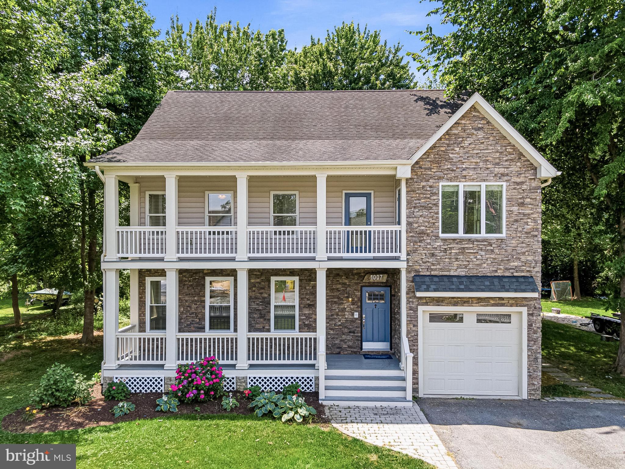 Nestled in the heart of historic Galesville, this beautifully updated coastal residence offers picturesque views of the West River and an exceptional lifestyle just steps from the waterfront. Enjoy water views from the front porch and upper-level balconies while living within walking distance of marinas, waterfront restaurants, the sailing club, Galesville Wharf Park, athletic fields, and local shops.
Designed for both everyday living and entertaining, this freshly painted home features hardwood flooring, brand new carpeting, an open updated kitchen with quartz countertops, stainless steel appliances, and abundant cabinetry, along with flexible living spaces that easily accommodate guests. A main-level bedroom with hardwood floors and full bath provide convenience for visitors or multigenerational living, while the spacious primary suite offers balcony access, water views, a walk-in closet, and a spa-inspired bath. Upper level laundry adds convenience. Two additional bedrooms served by a Jack and Jill Bath.
The uppermost level spans the width of the home and includes a full bath, creating endless possibilities as a fifth bedroom, media room, studio, or game room. The rear of the property includes a large slate patio which backs to a wooded area, providing a peaceful natural setting and added privacy.
Experience the charm of one of Anne Arundel County's most beloved waterfront villages, where boating, sailing, dining, and waterfront recreation are part of everyday life. 
This property qualifies for USDA financing.  USDA financing is a mortgage program backed by the United States Department of Agriculture that helps eligible buyers purchase homes in designated rural and suburban areas with 100% financing.