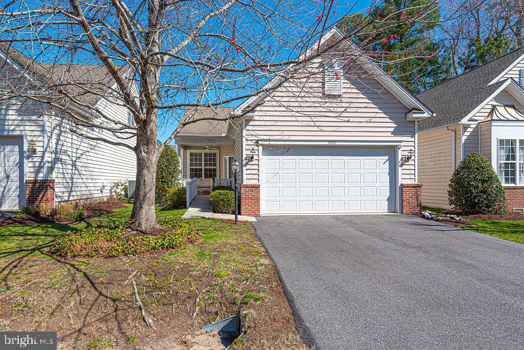 Welcome to this beautifully maintained Cormorant model home in the highly sought-after Premier Plus 55+ community of the Parke at Ocean Pines. This charming 3-bedroom, 2-bath residence offers the perfect blend of comfort, style, and low-maintenance living. A welcoming front courtyard sets the tone for this inviting home—perfect for relaxing mornings or greeting guests. Step inside to discover an upgraded kitchen designed for both function and style, featuring a center island, pull-out cabinetry, an oversized pantry, and a bright breakfast room ideal for casual dining. Hardwood flooring flows throughout the kitchen, hallway, great room, and third bedroom or den, creating a warm and cohesive living space. The spacious great room is enhanced by elegant crown molding, which continues throughout the home, adding a refined touch to every room. The versatile third bedroom can easily serve as a den or home office. The primary suite offers a comfortable retreat with plush carpeting, while the secondary bathroom has been thoughtfully updated with a new handicap-accessible tub/shower combination. Additional highlights include a large laundry room complete with a laundry tub, a wheelchair ramp in the garage for enhanced accessibility, an encapsulated crawl space for improved energy efficiency and moisture control, and a newer roof providing added peace of mind. Step outside to a beautifully landscaped backyard featuring a brick paver patio overlooking a serene small pond—perfect for entertaining or enjoying peaceful evenings surrounded by nature. Complete with a 2-car garage and located in a vibrant, amenity-rich community, this home offers easy living at its finest. Don’t miss your opportunity to enjoy everything the Parke at Ocean Pines lifestyle has to offer!