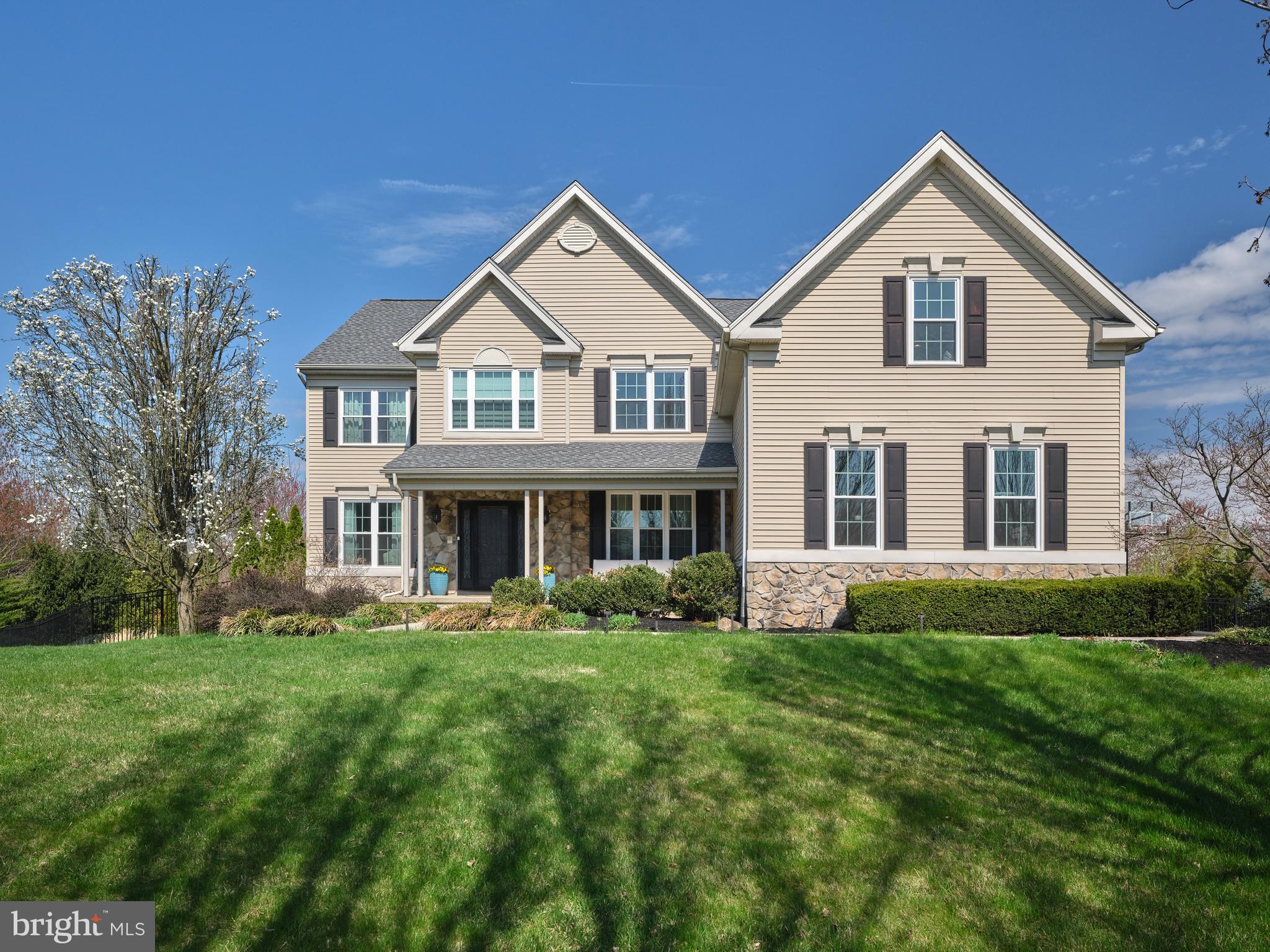 Welcome to 3402 Wiltshire Rd, an exceptional residence in the highly sought-after Devonshire Estates community, ideally located across from the charming gazebo park. This impressive two-story home offers 5 bedrooms, 3 full and 2 half bathrooms, and nearly 6,000 square feet of beautifully finished living space, including the lower level. A welcoming foyer with new wide-plank oak hardwood flooring sets the tone, flowing throughout the entire first floor of the freshly painted, neutral interior. Flanking the entry
are a spacious living room and an elegant formal dining room, both enhanced by crown molding, exquisite wainscoting, and refined finishes. The heart of the home is the inviting family room, featuring a cozy gas fireplace and serene views of the meticulously landscaped backyard, complete with a fully fenced, heated saltwater pool with a tranquil waterfall. The adjacent, newly renovated gourmet kitchen is a true showpiece, boasting high-end stainless steel appliances including Viking and Thermador, sleek quartz
countertops, a dramatic waterfall island with seating and storage, marble chevron tile backsplash, under-cabinet lighting with outlets, a dedicated water purification faucet, entertainment bar and a generous pantry. A sliding glass door leads to a spacious covered porch with a ceiling fan and outdoor heaters—perfect for entertaining while overlooking the private backyard oasis that backs to a scenic walking trail. Also on the main level is a private office with double doors, five custom built-in units, and wood blinds, along with a convenient half bath and laundry room. Upstairs, the  renovated luxurious  primary suite impresses with a tray ceiling, two custom walk-in closets, and an expansive open dressing room. The spa-like primary bath features dual vanities, a soaking tub, and a separate shower. A secondary en-suite bedroom with private bath and custom built-ins provides ideal accommodations for guests, while additional generously sized bedrooms—including one with double pocket doors—share a well-appointed hall bath with double vanity. The finished walkout lower level offers incredible versatility, complete with a bar area, home theater/media room, gym, bathroom, and abundant storage, with direct access to the patio, pool, and hot tub. Additional highlights include a new roof, whole-house water softener and filtration
system, a 3-car garage, and a storage shed. Enjoy a walkable lifestyle with close proximity to the community playground, walking trails, and three  gazebo parks. Conveniently located near Doylestown’s shopping and dining, this remarkable home is part of the award-winning Central Bucks School District.