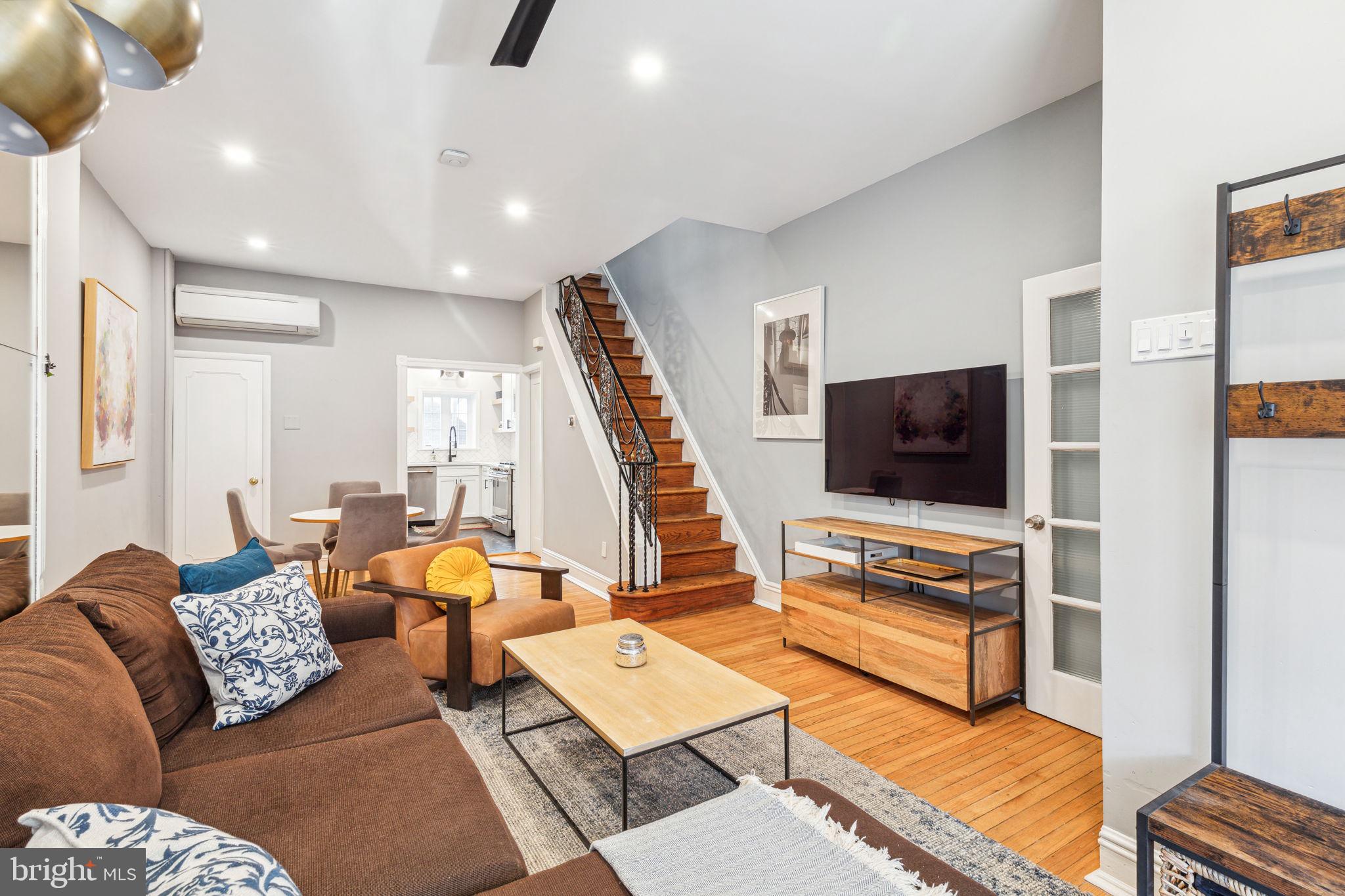 Tucked away on one of the most charming little blocks, in an incredible Passyunk Square location, is this 3 bedroom, 1.5 bathroom home with original charm and modern amenities! Enter through the home’s tiled vestibule which leads into an open concept first floor with high ceilings and hardwood flooring. A huge front window allows light to pour in. You’ll love the character this home displays in its wide baseboards, the iron railing, built-in bookshelves and more. Past the dining area is a bright and airy renovated kitchen featuring black hexagonal tile flooring, quartz countertops, a herringbone subway tile backsplash, stainless steel appliances, ample white shaker cabinetry, and open oak shelving for displaying your cookbooks and favorite kitchen items. From the kitchen, exit to the back patio which is perfect for your grill and a seating area where you can sip cocktails with friends or enjoy your morning coffee. A half bath with subway tiling completes this level. At the top of the stairs, you will be greeted by the first, of 3 bedrooms, which boasts hardwood floors with a beautiful inlay, plus exposed beams, and whitewashed brick. The middle bedroom, with crown molding and hardwood floors, makes an ideal home office, Peloton room, nursery, or turn it into the walk-in closet of your dreams! The front bedroom is the largest and includes ample closet space, parquet flooring, and a large bay window. The sunny and modern, but classic, full bath showcases black and white mini hexagonal tiling, a subway tile shower surround, a dark grey quartz countertop, and skylight. The large unfinished basement houses the washer and dryer and provides ample storage. Just a few blocks from Passyunk Ave, you’ll have some of the city’s best establishments at your fingertips! Feast on delicious Mexican food at El Chingon, grab a cannoli at the famous Termini Bros bakery, enjoy a cup of coffee from Rival Brothers, or expand your palate with Asian fusion delicacies from Bing Bing Dim Sum, just to name a few.