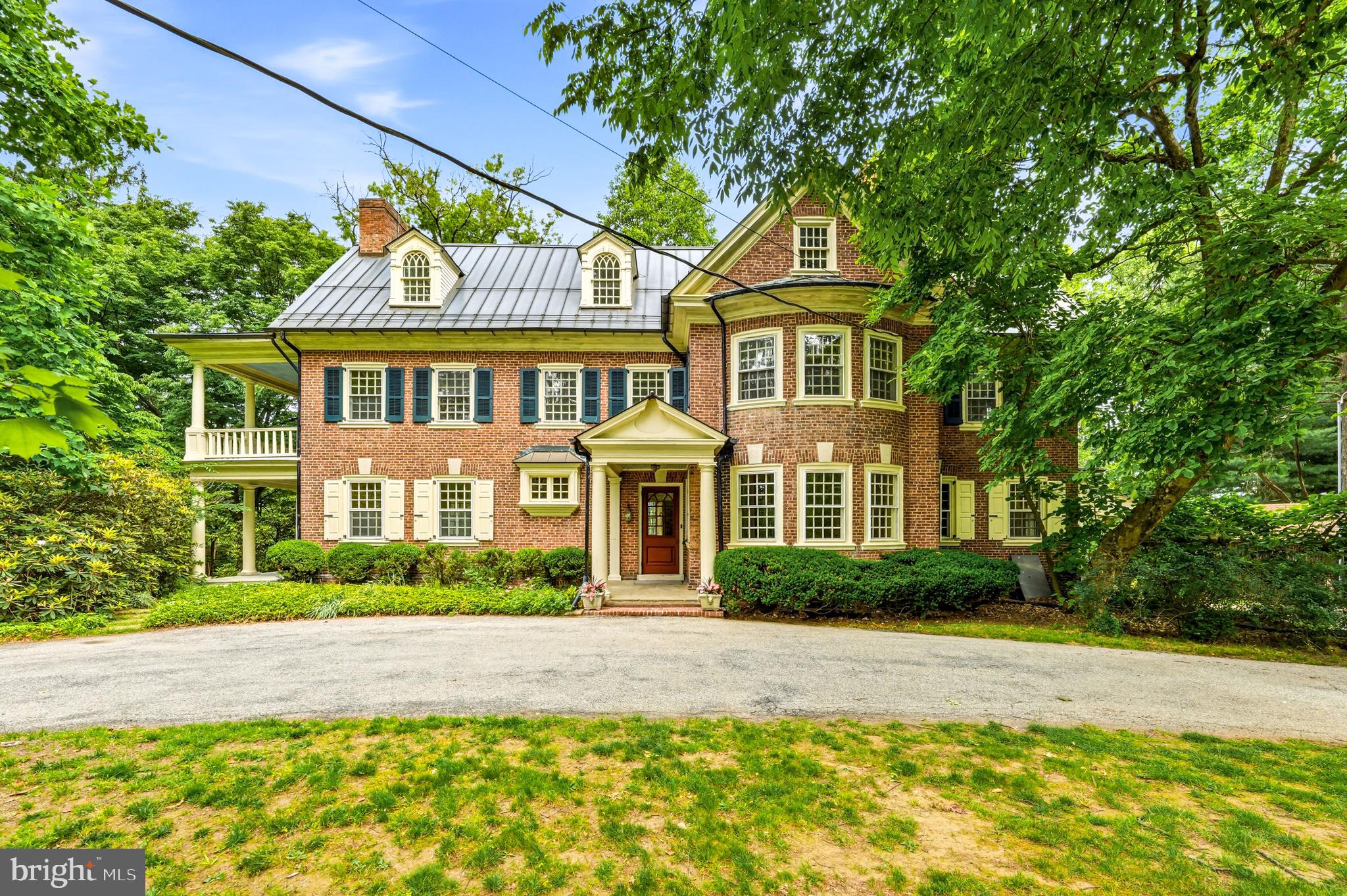 Welcome to 443 Saint David’s Avenue, one of Wayne’s most distinguished, historic residences. Built in 1901, the home has been owned by only THREE families-the first of whom was the Rosengarten family who gave us Chanticleer! Set on 1.35 gracious acres within one of the Main Line's most coveted neighborhoods, this landmark brick Colonial offers 5,575 square feet of bright, airy living space where magnificent period details and extraordinary millwork tell the story of a home built to last generations. Will you be the fortunate new steward?

As you approach the home down the long driveway, you immediately sense the grace and grandeur in the brick construction with curved walls, multi-level porches and an abundance of windows. Mature trees offer both shade and privacy. The large circular driveway provides ease of access, and the location where the current owner's children learned to ride their bikes many years ago. Once inside, a charming glass-top Dutch door opens from the vestibule to reveal the first of many delights: a cozy entry parlor bathed in natural light coming in from incredible curved, double-paned, Palladian windows.  This room is warmed by its own fireplace-the first of six inside the home- setting an immediate tone of intimacy and craftsmanship. The formal living room is a refined space, with a fireplace at the center and a coffered ceiling that crowns the room with fine detail. French doors lead you into the living room from the parlor, and another set leads you outside to an airy patio, where you can enjoy views of the side and rear yard in all four seasons. Through yet another set of french doors, you will find the impressive dining room - with its curved wall of windows and another cozy fireplace creates the perfect setting for a memorable holiday meal. Travel through the charming butler's pantry on your way to the large eat-in kitchen and bright, vaulted great room, added in the 1990's. This addition includes a full bath and laundry room and is the heart of everyday living- marrying the home's historic character with the open, relaxed scale today's buyers seek. A large fireplace flanked by two sets of French doors lead to the rear patio. Sweeping views of the property and another fireplace invite year-round alfresco entertaining surrounded by the beauty of nature.  An immense sycamore tree provides a lush, green canopy over the patio. 

The two upper floors include six bedrooms and three additional full baths - all sun-filled rooms graced with the artistry that defines the finest homes of the era. Ample closet space allows for plenty of storage, rarely found in homes of this vintage.

A standing seam copper roof crowning the entire home offers the peace of mind of modern infrastructure wrapped in the enduring elegance this property deserves. The many porches and terraces of this magnificent home offer a multitude of vantage points over the park-like grounds that offer both privacy and tranquility.

This home is located in the award-winning Radnor Township School District — rated among Pennsylvania's finest — and just moments from the St. Davids train station, the vibrant shops and restaurants of downtown Wayne, Chanticleer Garden, and the Radnor Trail. Center City Philadelphia is a relaxing 25-minute train ride away.

This is Main Line living at its most authentic and enduring. Don’t miss the opportunity to customize this special home as you make it your own!
