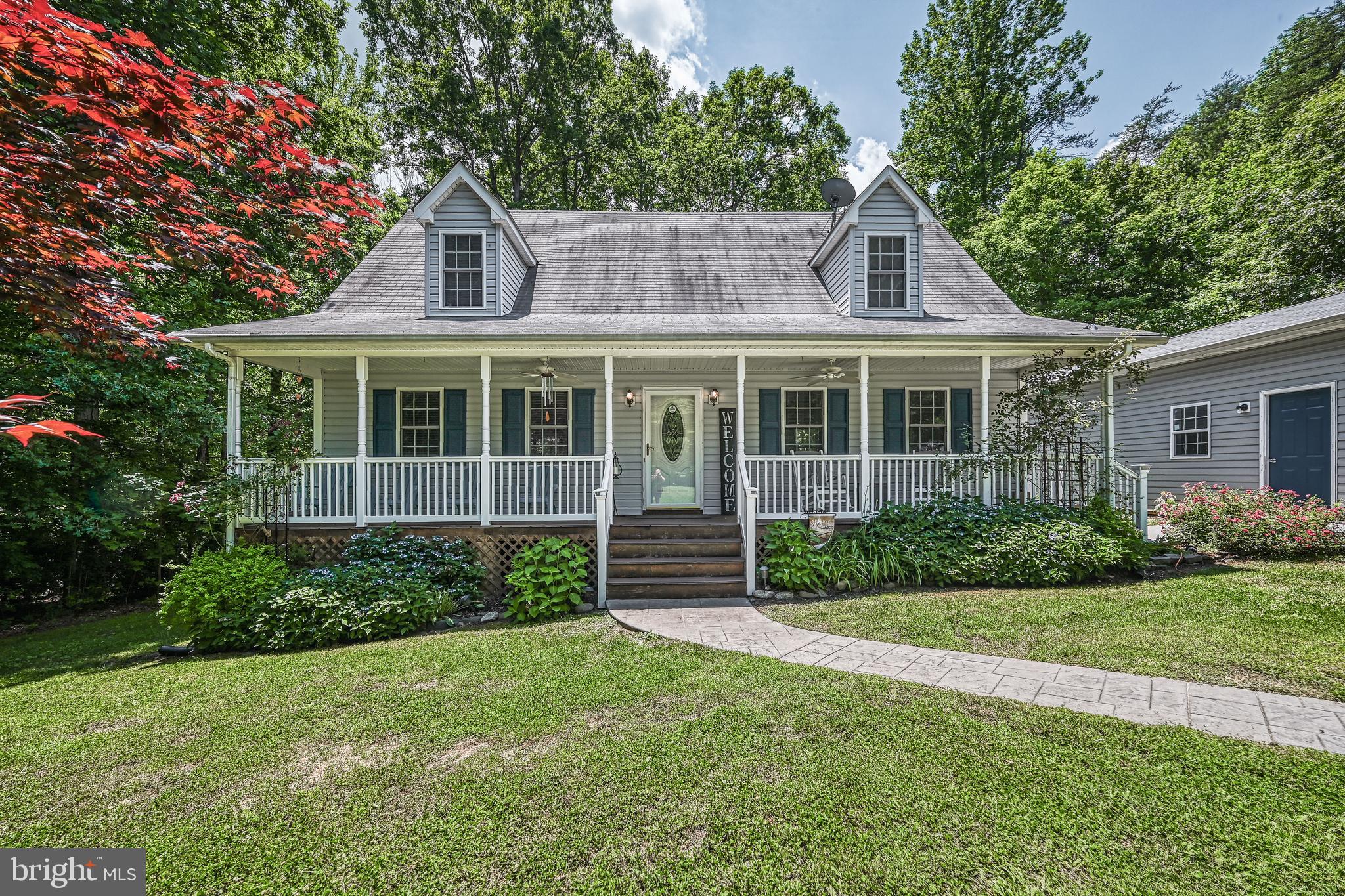 Welcome to Total Escape, located in the sought after Tall Pines subdivision on the public side of Lake Anna! This water access property sits on 1 acre and comes fully furnished, making it move in ready or a turnkey investment opportunity! The open main level floor plan is perfect for hosting, featuring a primary suite with seperate shower and soaking tub. Upstairs you will find two additional bedrooms, a full bath, and sitting area. Newly upgraded quartz countertops and a finished garage space designed as a fun family game room!
Step outside to your back patio for summer grilling or relax on your screened in porch. Take a quick golf cart ride to the waterfront common area, where you'll have access to a boat slip, ramp, beach, & pavilion. Prime location near local restaurants and wineries. Don't miss this chance to own your piece of Lake Anna living!