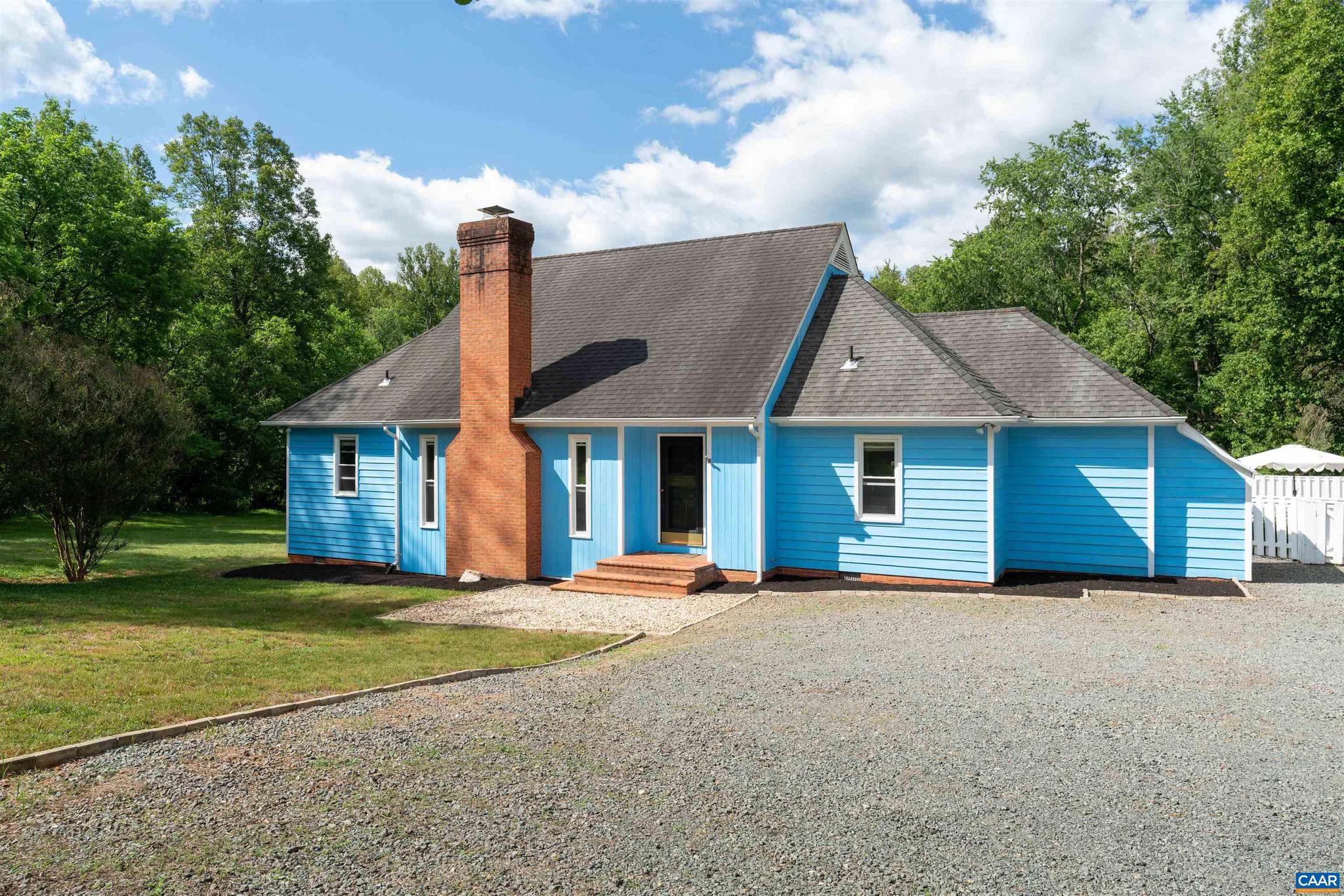 Just 15 minutes west of Charlottesville and UVA, this custom-built Western Albemarle home sits on 2.1 beautifully landscaped, private acres. Combining classic charm with modern updates, this 3-bedroom, 3.5-bath residence with abundant natural light boasts an effortless flow from the living area with soaring ceilings, to the loft with a Chippendale railing, to the main-level primary suite featuring a fully remodeled bath (2026). The primary suite and living areas open to an expansive rear deck overlooking a fenced 16x32 swimming pool with custom concrete pavers. Each spacious bedroom features an attached full bath and ample closet space. Notable features include premium laminate flooring, a brick fireplace, French doors, insulated windows, whole-house PEX plumbing, an updated water heater, and cypress siding. This move-in-ready home offers the perfect blend of secluded country living in a highly sought-after Albemarle County location.,Formica Counter,Oak Cabinets,Painted Cabinets,White Cabinets,Fireplace in Living Room