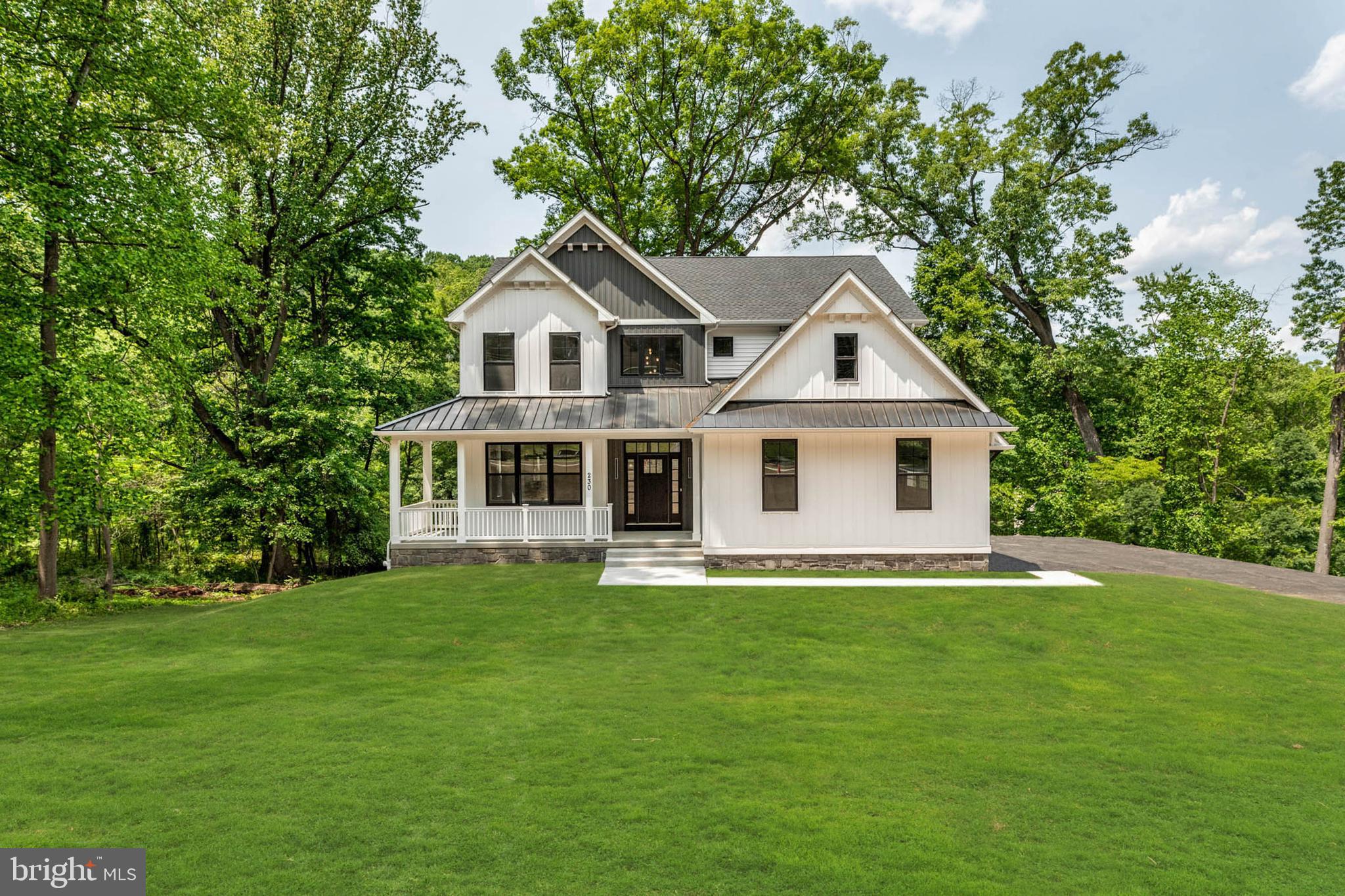 Located on a serene, wooded lot in Conshohocken, this exquisite 4-bedroom, 3-full and 1-half bath modern farmhouse offers the perfect blend of luxury, comfort, and convenience. A gracious covered front porch leads into a dramatic two-story foyer with wide-plank hardwood flooring throughout. The elegant formal dining room flows into a beautifully appointed Butler’s Pantry with a prep-sink and walk-in pantry, ideal for entertaining. The stunning chef’s kitchen features abundant custom cabinetry, premium finishes, and an oversized center island, opening seamlessly to the sun-filled Great Room with fireplace and access to the expansive rear covered porch, perfect for indoor-outdoor living.  A thoughtfully mud-room area offers custom built-ins, a powder room, and access to the 2-car garage equipped with electric vehicle charging. Upstairs, the luxurious primary suite boasts dual walk-in closets and a spa-inspired bath with soaking tub, walk-in shower, dual vanities, and private water closet. Three additional bedrooms with walk-in closets share a sophisticated hall bath, while a spacious laundry room completes the level. The fully finished walk-out basement provides exceptional bonus living space with a bedroom and full bath, ideal for guests, extended family, or a private office or gym., and opens directly to the fenced-in rear yard, offering privacy and the perfect space for outdoor enjoyment.
Ideally located near major roadways, regional rail, and the vibrant dining and shopping of Conshohocken and the Main Line. A rare opportunity home in an exceptional setting.