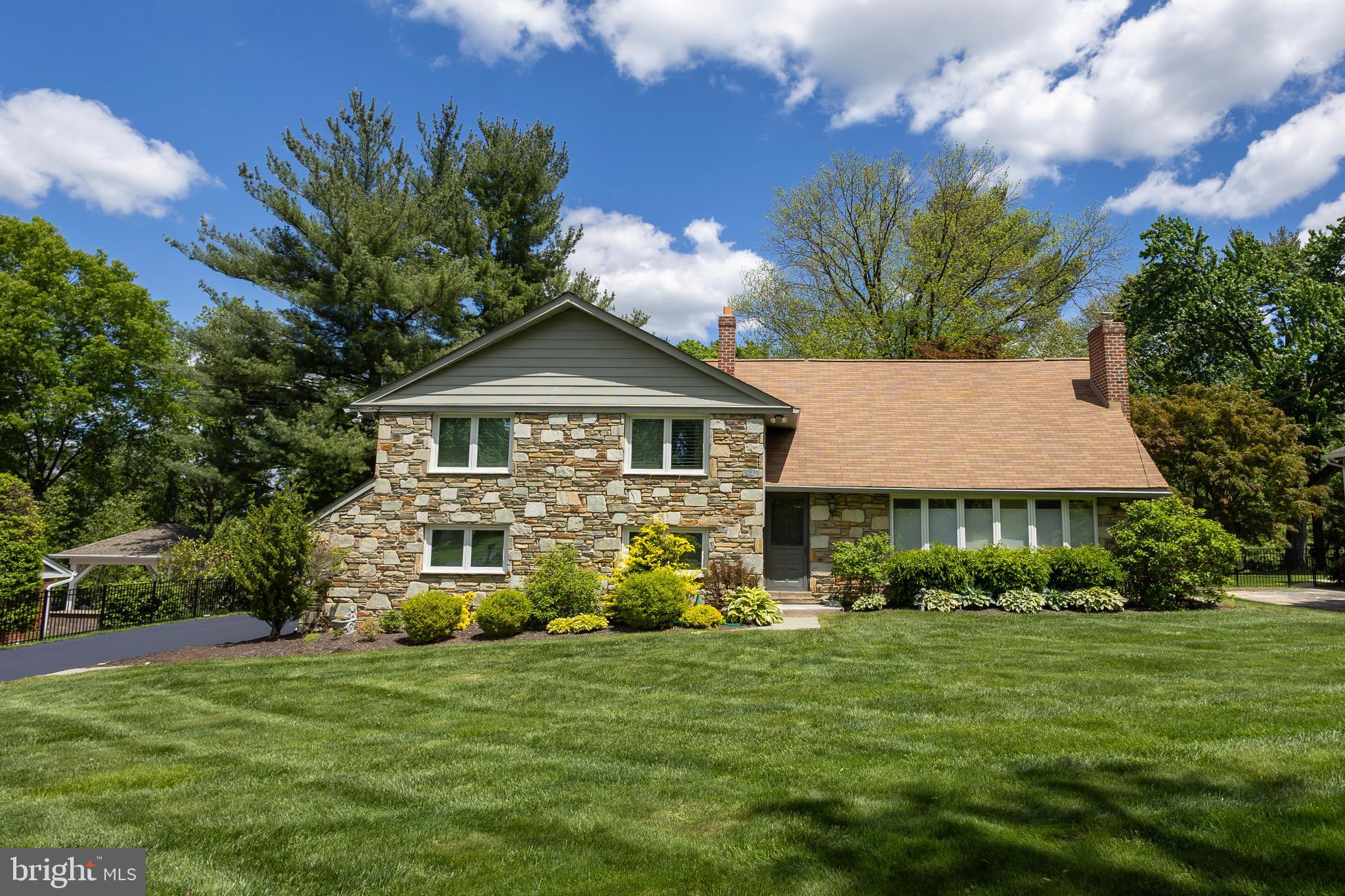 Welcome to this beautifully maintained 4-bedroom, 3 full bath split-level home nestled on a spacious and manicured 0.68-acre lot in the heart of Penn Valley. This bright and inviting residence offers a perfect blend of classic charm and modern updates, ideal for comfortable family living and entertaining. 
The formal living room is bathed in natural sunlight and features gleaming hardwood floors and a stunning wood-burning stone fireplace, creating a warm and welcoming atmosphere. The hardwood floors continue into the formal dining room, perfect for gatherings and special occasions. The updated eat-in kitchen boasts ceramic tile floors, granite countertops, stainless steel appliances, and a view overlooking the expansive, level, fenced-in backyard—an ideal space for outdoor fun and relaxation. Step down into the cozy family room with a second fireplace, ceramic floors, access to the backyard, a newly renovated full bathroom, and a convenient laundry room. A few steps further lead to a versatile finished basement offering additional living space—perfect for a playroom, home gym, office, or media room. Upstairs, the primary suite features separate closets and a luxurious new ensuite bathroom with a glass-enclosed shower. This level has three additional spacious bedrooms and another beautifully updated full hall bathroom. Other features include a 2 car garage and new heating and air conditioning  unit.  Located in the award-winning Lower Merion School District, this home offers an easy commute to Center City with convenient access to major roadways. Close to top-rated schools, parks, and places of worship, this home truly has it all. Don’t miss your opportunity to own this wonderful home in a prime Penn Valley location!