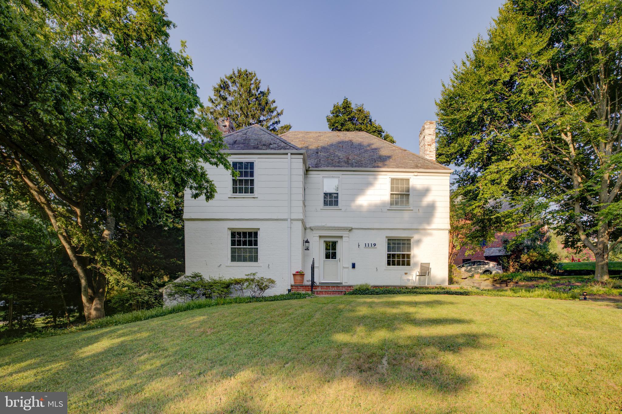 A rare opportunity in the well-established and sought-after Woodside Park. Prominently situated at the heart of the neighborhood and perched on a lush corner lot, this classic center-hall colonial welcomes you with four finished level, hardwood floors, generously sized rooms, multiple patios, and unique built-ins throughout.  

Step into the lovely front hall into a home designed for both elegant entertaining and comfortable daily living. The Formal Living Room is a light-filled space anchored by a stunning wood-burning fireplace and large windows. The magnificent Formal Dining Room features classic chair-rail molding and two authentic, built-in corner cabinets, perfect for hosting elegant meals. The kitchen is centered around a classic, deep farmhouse sink and sits adjacent to a cozy den/office with built-in bookcases. Past the kitchen and den is a grand family room with a powder room and exterior doors leading to each side yard patios. 

Ascend the grand wooden staircase to find a charming window seat with under lid storage flanked by convenient built-in closets. The upstairs hall opens to three bedrooms and two additional linen closets. 
The Primary Suite is a light-filled retreat featuring a private en-suite updated full bathroom (2022) and a generous walk-in closet. Two beautiful bedrooms share an exquisite full hall bathroom equipped with a tub. Up an additional flight of stairs is a fully finished attic bedroom and two large storage rooms. The mostly finished lower level boasts an additional family/living room complete with a second wood-burning fireplace. This level also includes a dedicated laundry room, workshop, and a well-placed half bathroom. 

Enjoy seamless access into the home via the attached garage (buyer can install a new garage door) or the multiple walkways. The driveway provides abundant parking for residents and guests alike. Location is unbeatable; a quiet and scenic home close to DC and commuter routes including walking distance to the metro and world class dining and entertainment in downtown Silver Spring.