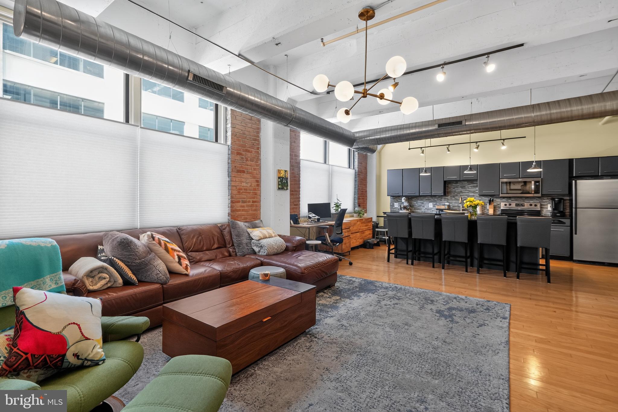 444 N 4th Street, Unit 202 | 444 Lofts | Northern Liberties / Old City
2 BD | 1.5 BA | 1 Parking Space Included | 8x10 Separate Secured Storage Space

Welcome to Unit 202 at the iconic 444 Lofts, one of Philadelphia's most sought-after warehouse conversion communities perched at the crossroads of Northern Liberties and Old City. This thoughtfully upgraded 2-bedroom, 1.5-bathroom condo is the perfect blend of industrial character and refined modern living.

From the moment you enter, the scale of this loft-style home impresses. Oversized windows flood the space with natural light throughout the day, highlighting soaring concrete-beamed ceilings and the warm wood flooring installed by the current owners. The open-concept living area flows beautifully into the kitchen, anchored by a stunning 10-foot granite island, ideal for entertaining or everyday life. Pendant lighting over the island and upgraded track lighting with dimmer switches in the living room add atmosphere and flexibility.

The primary bedroom is a true retreat, featuring custom California Closets and a fully remodeled en suite bathroom completed in July 2022. The spa-inspired bath includes both overhead and side shower heads, upgraded fixtures, lighting, and flooring. Space-saving pocket and barn doors keep the layout feeling open and functional throughout the hallway. The second bedroom also features custom California Closets storage. The living room showcases a custom California Closets entertainment center, adding both style and smart storage to the heart of the home. A stylishly updated half bath is conveniently located near the entrance. Remote-controlled insulated cellular window treatments throughout add privacy and energy efficiency.

Additional in-unit upgrades include a new HVAC unit, a new water heater, and an in-unit washer and dryer. As one of the original owners at 444 Lofts, the sellers secured one of the most coveted storage units in the building, a free 8'x10' space located right at the bottom of the stairs and extremely convenient to the unit itself.

444 Lofts offers outstanding amenities: a 24-hour front desk, an 8,000 sq ft fitness center with a running and walking track, laundry and dry cleaning concierge, a dedicated bike room, and a pet-friendly policy with no weight restrictions. The lobby-level Be Well Fed cafe provides meal prep and food service, and Small World Seafood operates a retail outlet right off the main lobby.

Situated at the crossroads of Old City and Northern Liberties, residents enjoy easy access to cobblestone streets, boutique shops, and bustling nightlife on one side, and an eclectic mix of cafes, art galleries, and a thriving restaurant scene on the other. The building is minutes from the Ben Franklin Bridge and I-95, with a Walk Score of 94 and a Transit Score of 96, with 73 nearby transit routes. Target, Sprouts Market, and Yards Brewing are just blocks away.

One gated parking space is included. One 8x10 Storage Space