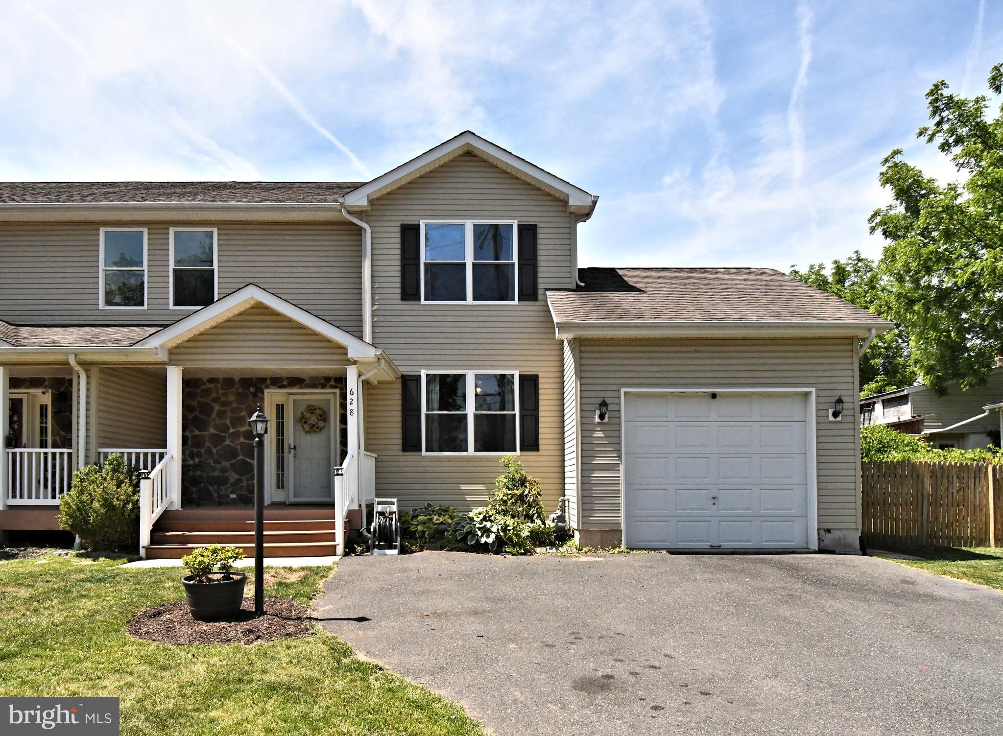 Spacious, inviting, and thoughtfully designed, this 3 bedroom, 2.5 bath twin home in the West Point area offers the comfort and presence of a single-family home with approximately 2,002 square feet of living space. Set on a quiet street with a covered front porch, private driveway, attached garage, fenced backyard, and covered rear deck, this home delivers a wonderful blend of indoor comfort and outdoor enjoyment.   The main level offers a bright and functional layout with flexible spaces for today’s lifestyle. Just off the entry, the front room provides wonderful versatility and could easily be used as a home office, sitting room, playroom, formal living area, or quiet reading space. The heart of the home features an open connection between the kitchen, dining area, and main living space, making it ideal for everyday living as well as entertaining.  The kitchen is well appointed with rich wood cabinetry, granite countertops, stainless steel appliances, gas cooking, recessed lighting, and a large center island with seating. There is plenty of workspace and storage, making this a comfortable kitchen for cooking, gathering, and hosting. The dining area opens directly to the rear deck, creating an easy transition for outdoor meals, morning coffee, summer grilling, or simply relaxing at the end of the day.  The covered deck overlooks the fenced backyard, offering a private outdoor setting with room to enjoy gardening, play, pets, or entertaining. Whether you are hosting friends or looking for a peaceful place to unwind, the backyard adds valuable living space and everyday enjoyment.  Upstairs, the primary suite offers generous space, two walk-in closets, and a private bath featuring a double vanity, soaking tub, and separate shower. Two additional bedrooms are nicely sized and offer great closet space. A full hall bath and a convenient second-floor laundry room complete the upper level.  Additional highlights include a main-level powder room, hardwood flooring in portions of the first floor, an attached one-car garage with storage, attic storage, and a full basement with excellent storage capacity and Bilco door access to the backyard. The home also features natural gas (not propane), adding comfort and efficiency.  Located in the North Penn School District, this home is close to local parks, shopping, dining, major routes, employment centers, and everyday conveniences. With its spacious layout, flexible living areas, outdoor space, and desirable location, this is a wonderful opportunity to own a well-sized home in the West Point area.