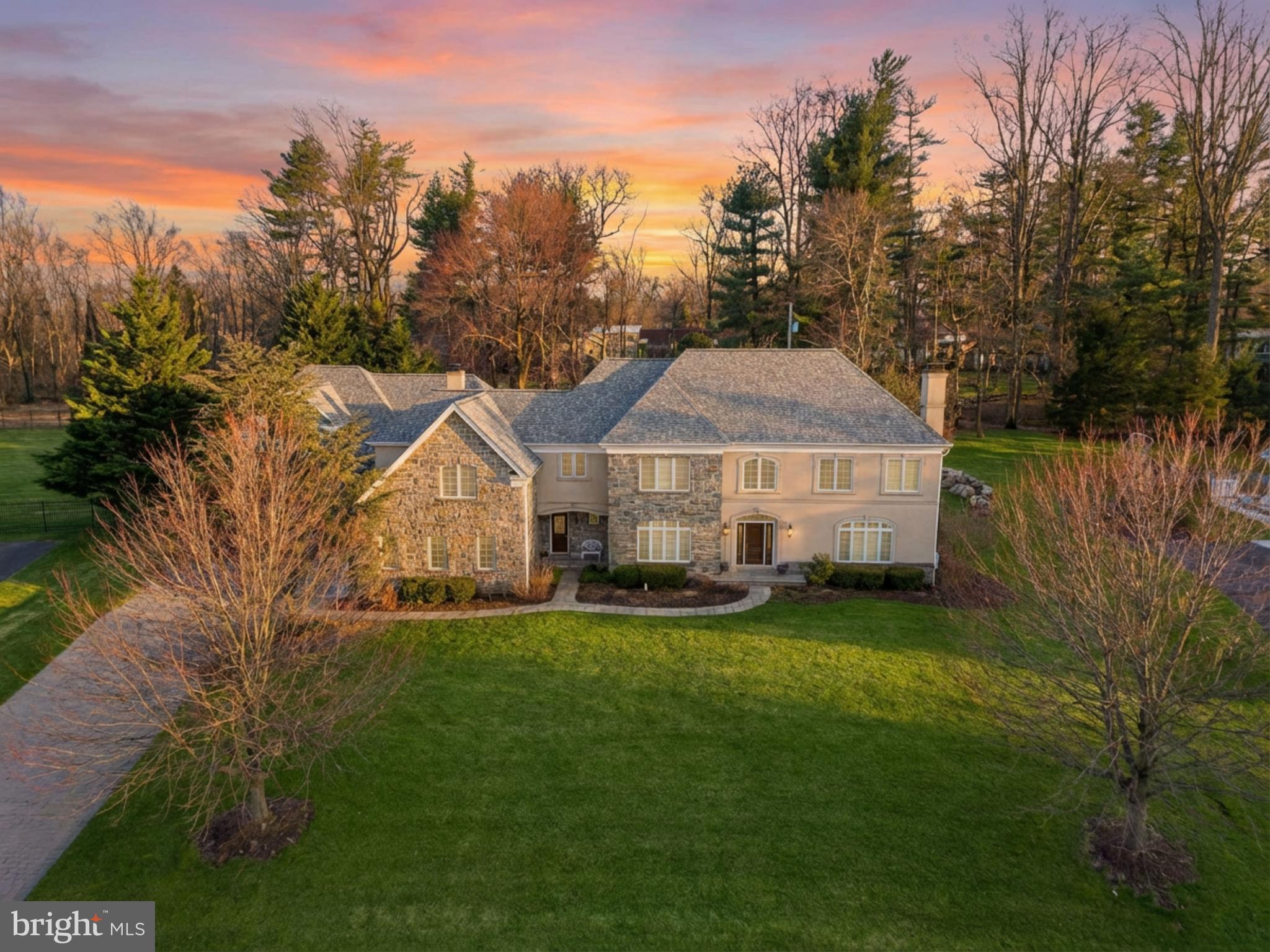 The Pinnacle of Luxury in Inverness | Exceptional Value & Modern Sophistication
Unmatched Grandeur with Significant Personalization Potential
Discover a rare opportunity to own a masterpiece of timeless elegance in the prestigious Inverness community on a quiet street. Set on nearly one acre of beautifully landscaped, level grounds backing to a manicured conservation of Pennypack land, this property is a masterpiece of upgraded quality. This home combines the renowned craftsmanship of a Dave Della Porta French Country design with extensive upgraded features including, an addition of two car garage with second floor in-law suite, custom Cherry kitchen, 3” hardwood flooring, Trane grade heating/cooling, central vac system and a new roof. Spanning over 6,000 square feet of meticulously designed living space, the residence opens with a dramatic grand entry hall featuring marble floors and a striking staircase. Soaring ceilings, with enhanced crown molding and custom base millwork flow through the formal living and dining rooms. The family room serves as the heart of the home, anchored by a gas fireplace and a window wall with French doors that frame serene views of the private backyard with large slate patio. The gourmet chef’s kitchen is a triumph of function and style. Renovated with premium finishes, it features custom hardwood cabinetry, and GE appliances with a commercial refrigerator. With a 5-burner gas cooktop, double ovens, a walk-in pantry, and a massive center island, it is perfectly equipped for hosting. An elegant butler’s pantry and a sun-filled breakfast area provide a seamless transition for formal and casual dining alike. The master bedroom complete with sitting area and a spa-like bath with a soaking tub is completed with double closets. The home accommodates multigenerational living with ease, featuring up to 5 bedrooms and 4 bathrooms in the main house. There are 2 half baths on the first floor as well. The addition with its enlarged entrance ways has an upstairs bedroom, full bath, living room, breakfast area and kitchen. There is a private office behind French doors, and a second floor laundry room for ultimate convenience. For car and sports enthusiasts there is oversized garage parking for 5 vehicles with the newer garage addition including heat to allow year round practice in the golf drive area. Don't miss the basketball court in the back by the large entertainment patio and level yard for various activities. Honorable mentions are the new roof in 2025, newer water heaters, irrigation system, and concrete stamped driveway. Schedule your private tour today.