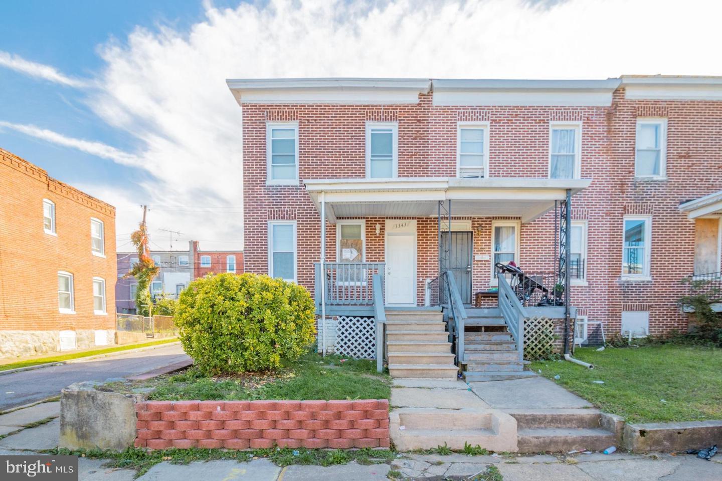 Welcome to 3343 Elmora Ave, a beautifully maintained and previously upgraded end-unit row home in the Four by Four Neighborhood. Immediately as soon as you arrive you will notice the covered front porch where you can relax or unwind. Step inside and you are immediately greeted by the ample living room with lots of natural lighting.  The kitchen offers stylish cabinetry and stainless steel appliances — perfect for anyone who loves to cook and entertain. From the kitchen, you can go to the backyard where you host summer gatherings on your own private yard — ideal for outdoor living and entertaining. Come back inside and ascend to the second floor where you will find 2 bedrooms and 1 beautifully upgraded full bath, which makes this an ideal home for those who no longer wish to rent and are seeking their first move-in ready home. For added storage, the fully finished basement offers just that as it offers lots of finished area and flexible space for a home office, guest suite, or rec room and another full bath. As an end unit, the home enjoys extra natural light.  This home is located just blocks from multiple parks, and only minutes from downtown Baltimore, this home blends comfort, convenience, and community living in one unbeatable package.