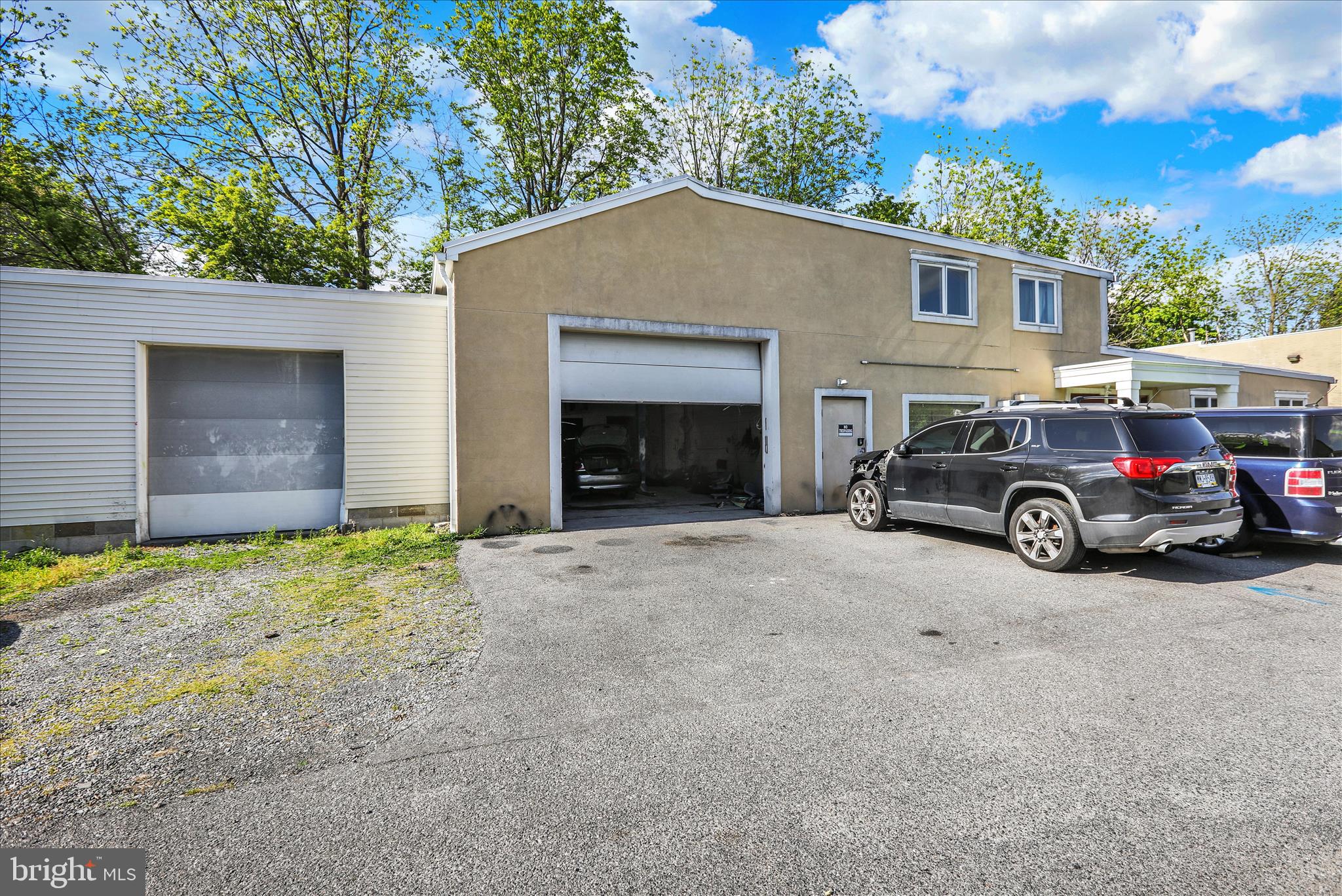 Unique mixed-use opportunity in West Lawn, Spring Township, within the Wilson School District. Located at 2125 Portland Ave, this property offers a flexible combination of residential, office, storage, and garage/shop space. The property includes a 2-bedroom residential unit, making it ideal for an owner-occupant, investor, or business user looking for added income potential.

The modern office space features private offices, a reception area, common work area, kitchenette/breakroom space, multiple restrooms, and additional storage areas. The layout provides excellent functionality for a variety of professional or service-based uses.

For users needing garage, contractor, automotive, or storage space, the property offers two attached garages, plus a large detached third garage with its own office space. The garage areas provide overhead doors, work areas, and substantial room for equipment, vehicles, materials, or business operations. Additional covered outdoor storage spaces further enhance the property’s functionality for equipment, inventory, materials, or vehicles.

This is a rare opportunity to combine residential living, professional office space, garage/shop space, and covered storage in one property.

This property will not last long. Schedule a showing today!