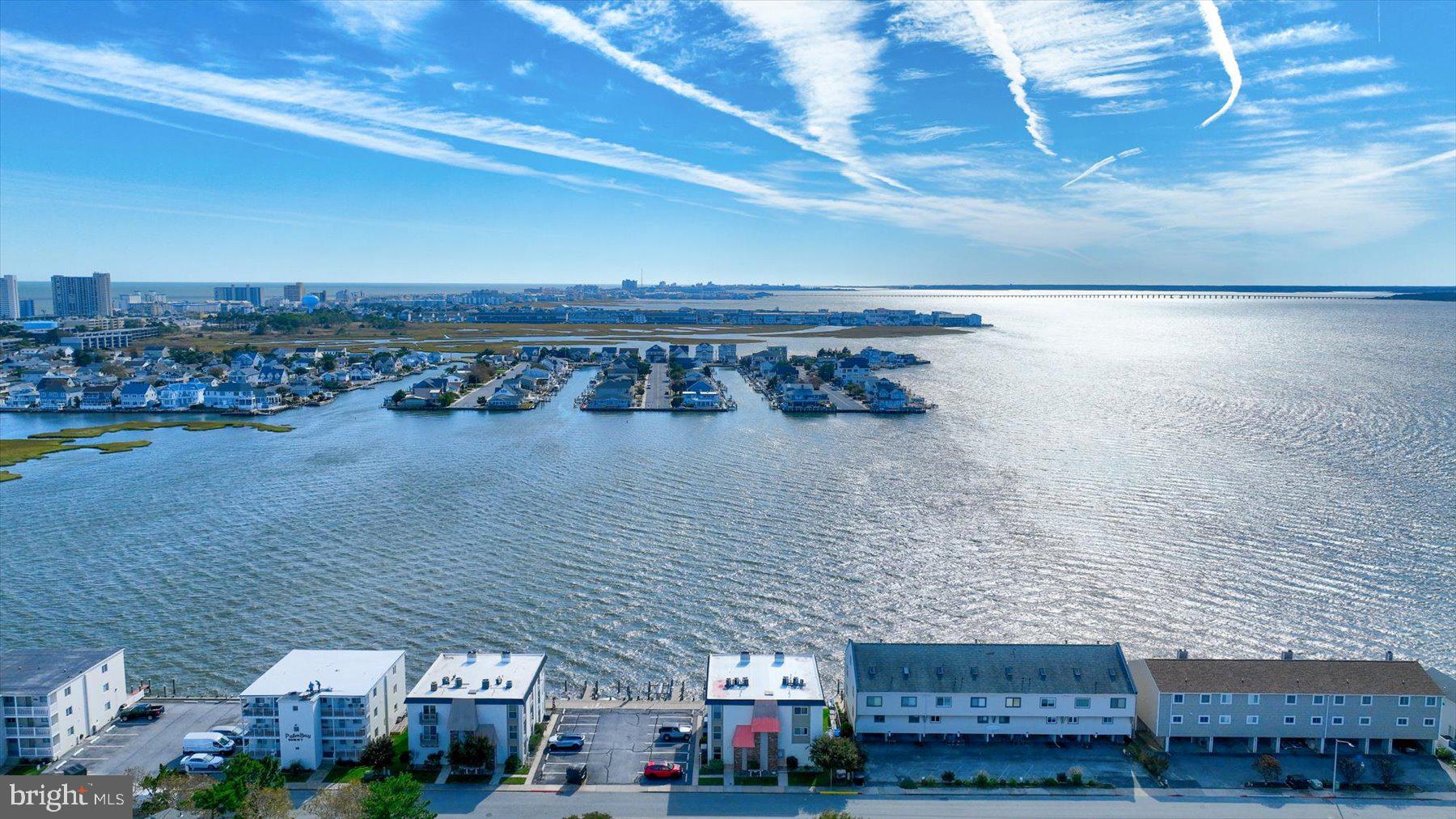 Welcome to 181 Jamestown Road #5, a rare opportunity to own a 2-bedroom, 2-bath direct bayfront condo offering an owners entrance and rear bayfront entrance, a private boat slip in the heart of Ocean City. A true boater’s paradise, this waterfront retreat offers easy access to the bay and endless days on the water. With low condo fees, no current assessments, and sweeping panoramic views, this property boasts what is arguably one of the most spectacular waterfront views in all of Ocean City, MD. Inside, the charming nautical theme provides the perfect décor, complementing the coastal setting and creating a relaxed waterfront atmosphere. A spacious living room opens to the dining area and galley style kitchen, offering plenty of cabinet storage and countertop prep spaces to create all your coastal favorites. This exceptional bayfront setting offers the quintessential Eastern Shore lifestyle, drop a crab pot from your pier and enjoy an abundance of fresh Maryland blue crabs right outside your door. Watch breathtaking sunsets from your private balcony and enjoy the best of coastal living just moments from the beach, dining, and entertainment. Whether you're looking for a primary residence, vacation getaway, or investment property, this is bayfront living at its finest.