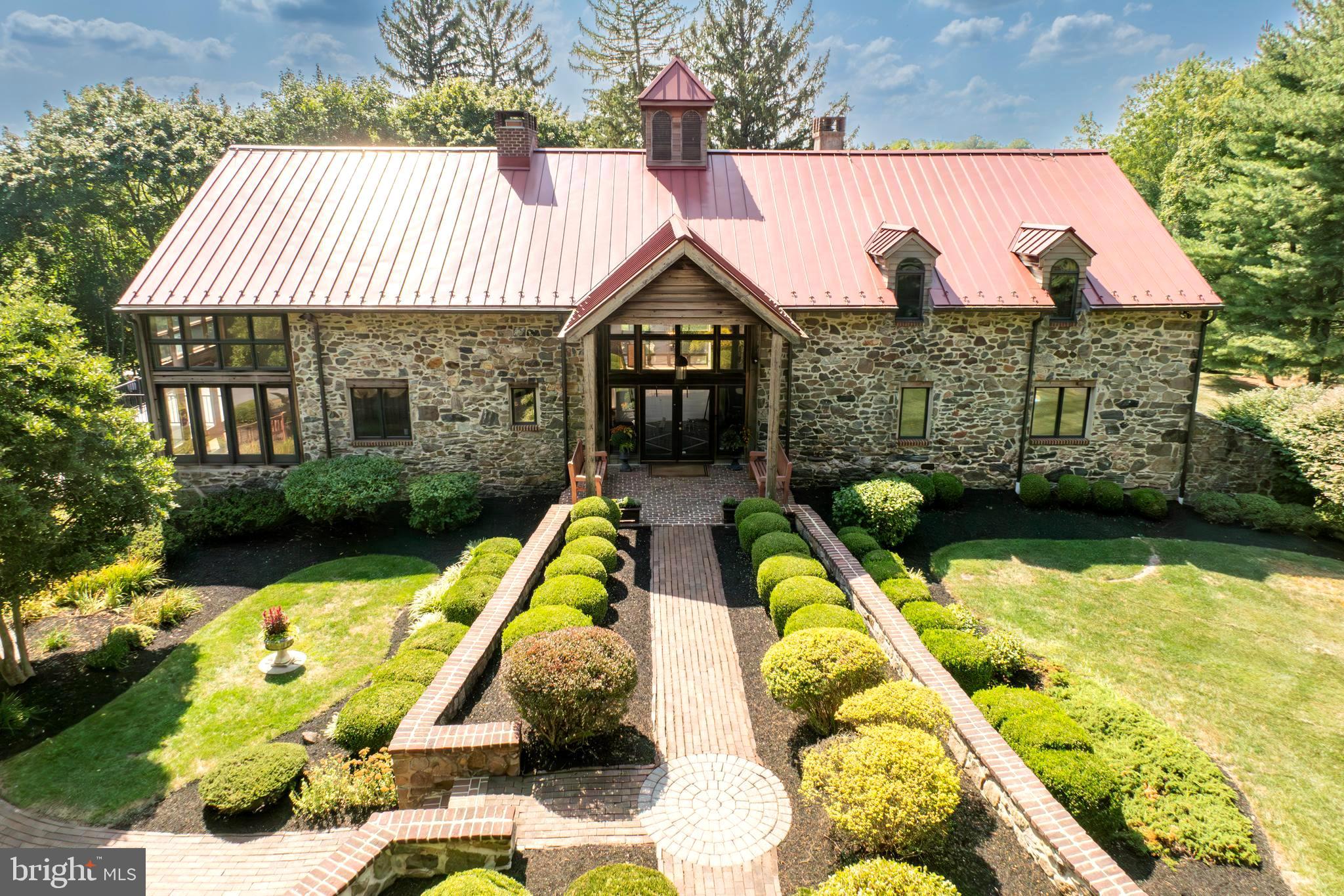 Rarely do you see a one of a kind completely updated Converted Barn in the heart of Chester County, only a few miles from the center of West Chester Borough become available for a new owner.   Originally built in 1840, this home boasts over 7,000 total Sq ft of living space, with a unique interior that was meticulously renovated to the highest standards in quality, yet preserved the intimate craftsmanship of days gone by. The highlights of this home are many and include a brand new Bluebell Fine Cabinetry and Design custom kitchen with a Wolf stove, Sub-Zero refrigerator with cabinet panels, both butcher block and quartz island, quartz countertops and custom built-in. The great room features a two story stone and brick fireplace, floor to ceiling Marvin Windows and a vaulted tongue-and-groove ceiling. The main floor also features a slate foyer, slate powder room, slate laundry and a vaulted tongue-and-groove ceiling dining room, also with floor to ceiling windows and french doors. The main living floor contains a separate den with a built-in and the primary bedroom.  The primary suite bedroom features vaulted ceilings, a walk-in closet with a custom California Closet and an attached primary bath featuring marble floors, a walk-in shower, granite vanity and Jacuzzi tub.  The main section of the second floor features a loft area great for a home office or sitting area, along with two guest bedrooms with 16 plus foot ceilings and a hallway full bath.  There is a second floor primary suite with ensuite bath containing ceramic tile and a walk-in shower, a large walk-in closet with California Closet built-ins and a sitting area. The full walkout lower level of the home features an additional approximate 2400 sq ft of living space with a wet bar and refrigerator, stone fire place, TV/media room, powder room, a large flex room, a workshop, arched doorways, chair rail, wainscoting and a door leading to an unfinished bonus room waiting for the next owner to put their touches on.  On this level is the three-car side attached garage with new epoxy flooring. The exterior of the home features breathtaking stone work, a standing seam metal roof installed in 2015, an Azek Deck installed in 2022 with built-in lighting, a detached studio which is perfect for storage or waiting for renovation.  The long driveway features a privacy gate.  This extravagant property is uniquely breathtaking and a must see! The grounds on this special property are also one of a kind.  There is separate “studio” building with wood cathedral ceilings, a wall of windows and stone structure that is beautiful on the outside with a newer metal roof and the interior space holds endless possibilities to make this building a special place for a studio, future Pool house or an indoor / outdoor recreational building.  There are brick walking paths and patio’s around this spectacular building that enhances your ownership experience.  Within the Award Winning West Chester School District and the location of this property just off Route 52 and S. Creek Rd makes for a perfect commute to West Chester, Wilmington, DE,  Philadelphia and King of Prussia.   

YOUTUBE LINK TO A PROPERTY VIDEO https://youtu.be/O1GhqngVIrI