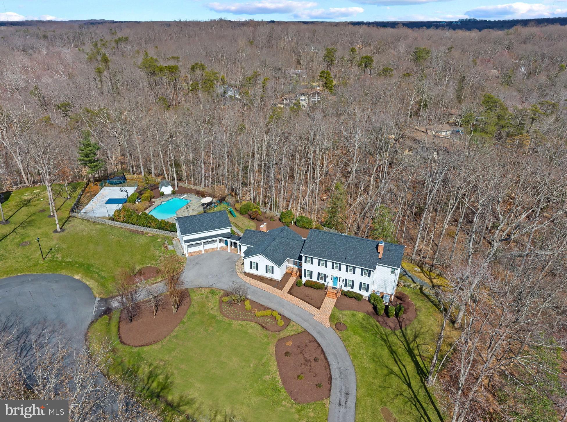 This beautifully updated, move-in ready 6-bedroom, 5 bathroom home is ideally located on a cul-de-sac in highly sought-after Harbor Hills waterfront community.  
Upon moving in in 2019 the owners made several upgrades to the interior and exterior of the house.  In 2021 the first floor area was completely renovated to open up kitchen and sunroom to the rest of the house.  The kitchen is a true show stopper and perfect for entertaining and family gatherings with a quartz island with seating for 6.  The kitchen is equipped with a beautiful farm sink as well as a prep sink in the island for ease.  Quality appliances throughout including a 36 inch column Thermador refrigerator and 18 inch Thermador freezer for plenty of space for a family. 
Upon entering the home from the detached garage there is a completely renovated mudroom with custom cabinets and lockers for storage for 4, shiplap throughout that continues through the first floor into the kitchen and sunroom.  The mudroom is also equipped with a  stackable washer and dryer for those pool towels when you come in from the pool area.  A separate laundry room on the other side of the house has a full size washer and dryer, brand new flooring, tons of storage cabinets, as well as a pantry.  
The first floor has a guest bedroom and full bathroom, as well as formal dining room.  Upstairs are 4 bedrooms including the primary suite with two walk in closets.  In 2019 new windows were installed throughout, 61 in total.  New roof installed in 2025 on the home and detached garage as well as new columns on the detached garage.  
The detached garage has shelves for storage in the main area and tons of storage on the second floor including a separate area with infrared heating panels installed for a hot yoga room, could be converted to work out room or office.  Fully finished basement with new floors and fresh paint, also includes a back room with infrared sauna.  
Step outside from one of your many entry and exit points to a true-backyard oasis.  A beautifully designed pool with plenty of space for relaxing and entertaining.  Beyond that is a fully lighted sport court for endless days with basketball or pickleball.  A perfect space for outdoor entertaining for the adults, kids, and their friends to play.
Harbor Hills enriches everyday life with an exceptional array of amenities. Residents enjoy a community pool and clubhouse that serve as the hub for social gatherings, along with tennis courts and a baseball field for recreation. The waterfront setting offers a beach, boat ramp, and marina for easy access to the water, while the waterfront pavilion provides the perfect backdrop for sunset evenings and community events. A playground and open spaces complete the setting, creating a neighborhood designed for connection, activity, and enjoyment.
Experience a lifestyle defined by the balance of privacy, recreation, and community where every day feels like a retreat and every season brings something to enjoy Welcome Home!